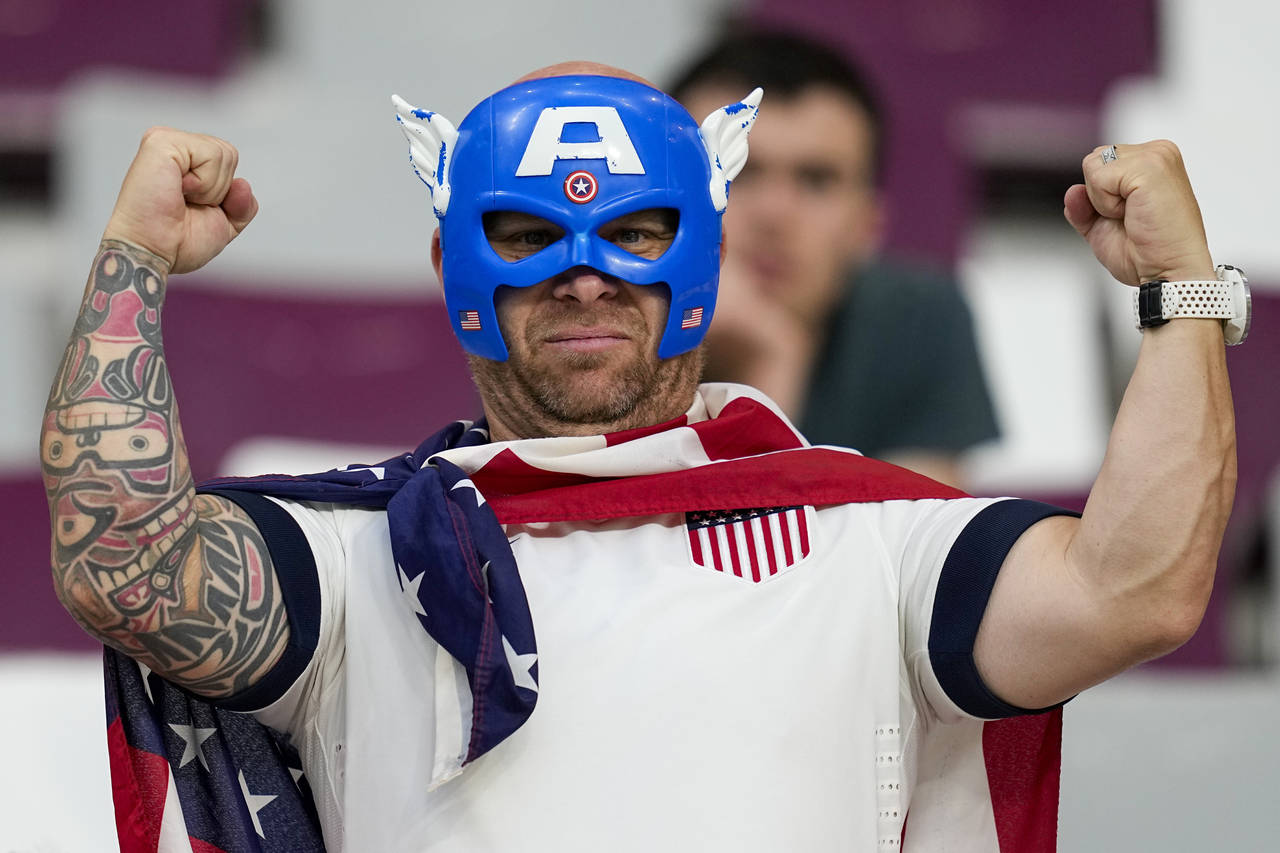 A a fan waits for the start of the World Cup round of 16 soccer match between the Netherlands and t...