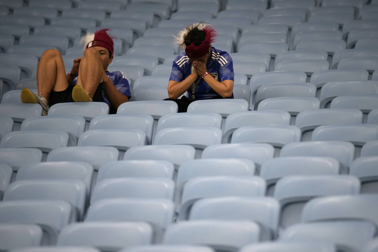 Fans of Japan react after Croatia won in the World Cup round of 16 soccer match between Japan and C...