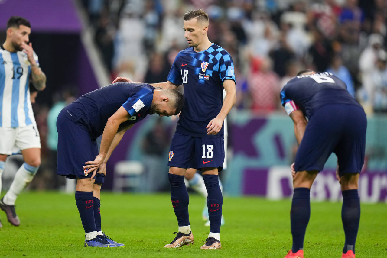 Croatian players react following the World Cup semifinal soccer match between Argentina and Croatia...