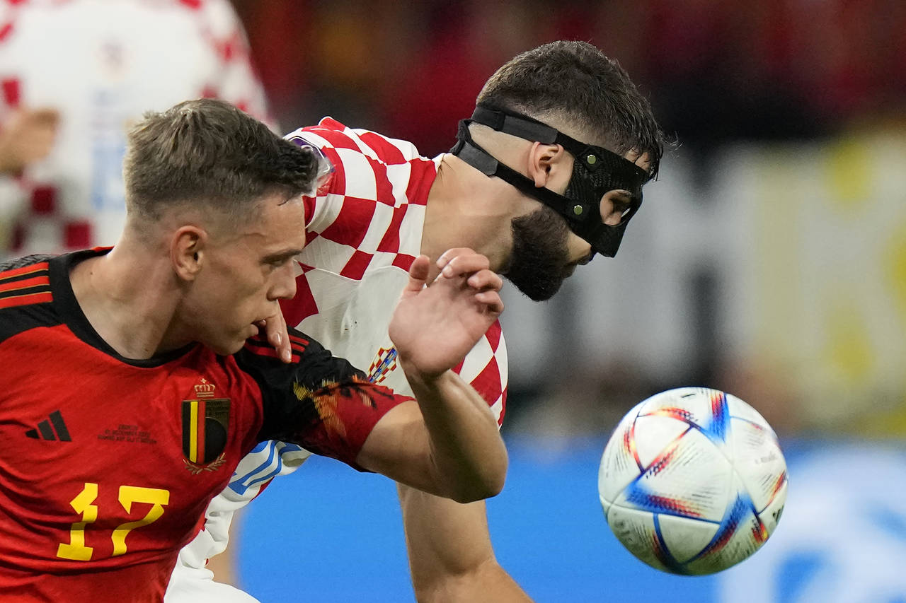 Belgium's Leandro Trossard, left, and Croatia's Josko Gvardiol fight for the ball during the World ...