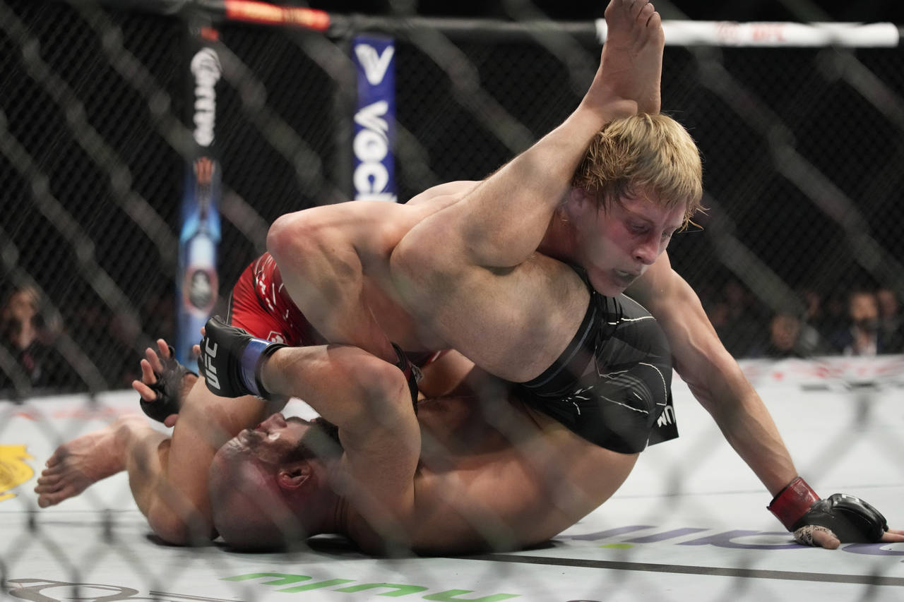 Paddy Pimblett, top, fights Jared Gordon during a UFC 282 mixed martial arts lightweight bout Satur...