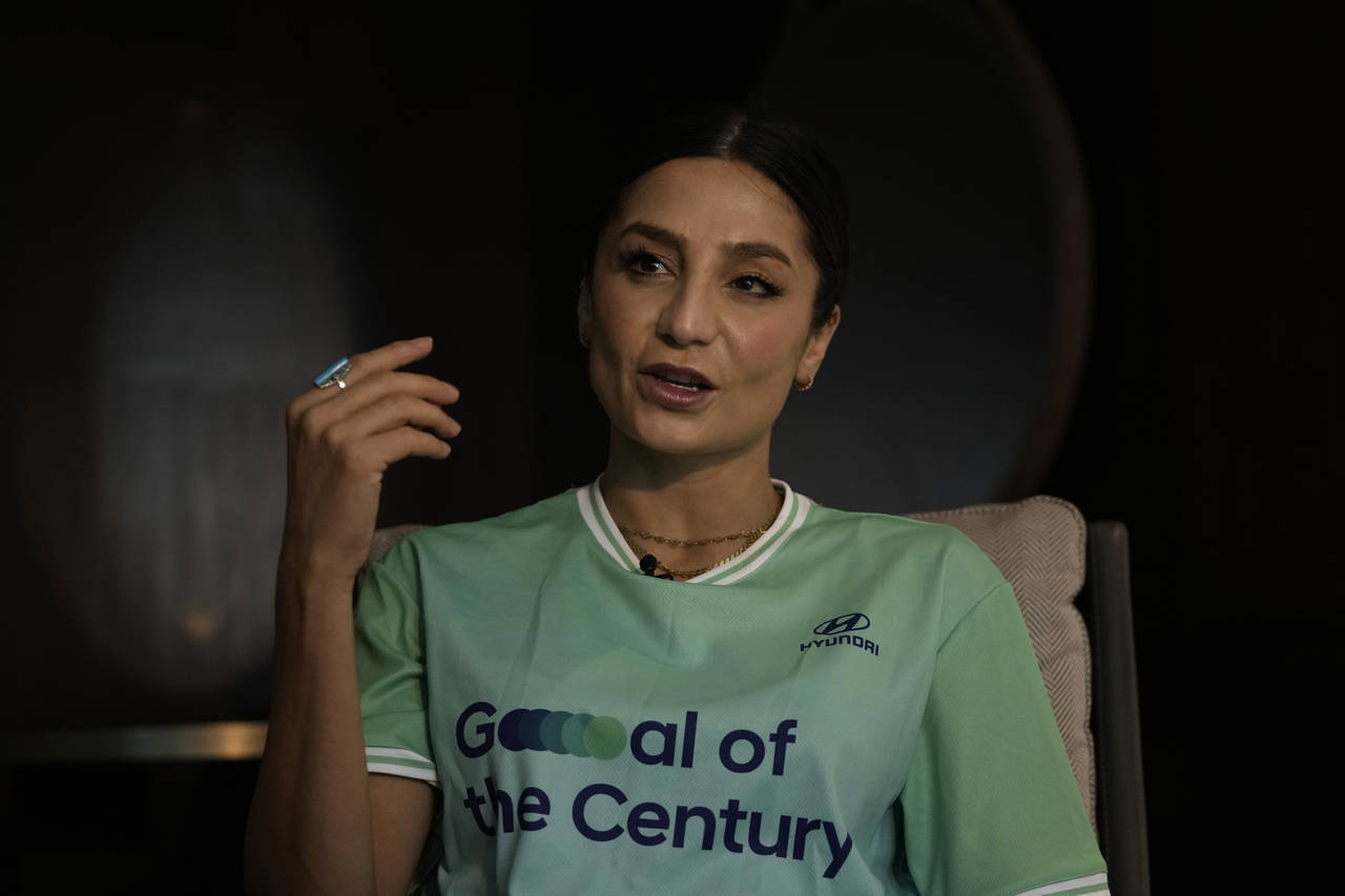 Nadia Nadim gestures as she speaks during an interview with The Associated Press in Doha, Qatar, Th...