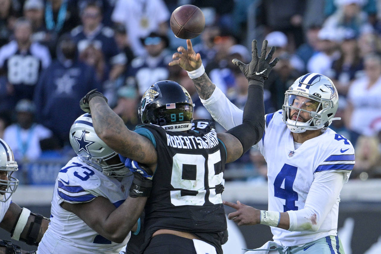 Dallas Cowboys quarterback Dak Prescott (4) throws an interception pass during overtime in an NFL f...