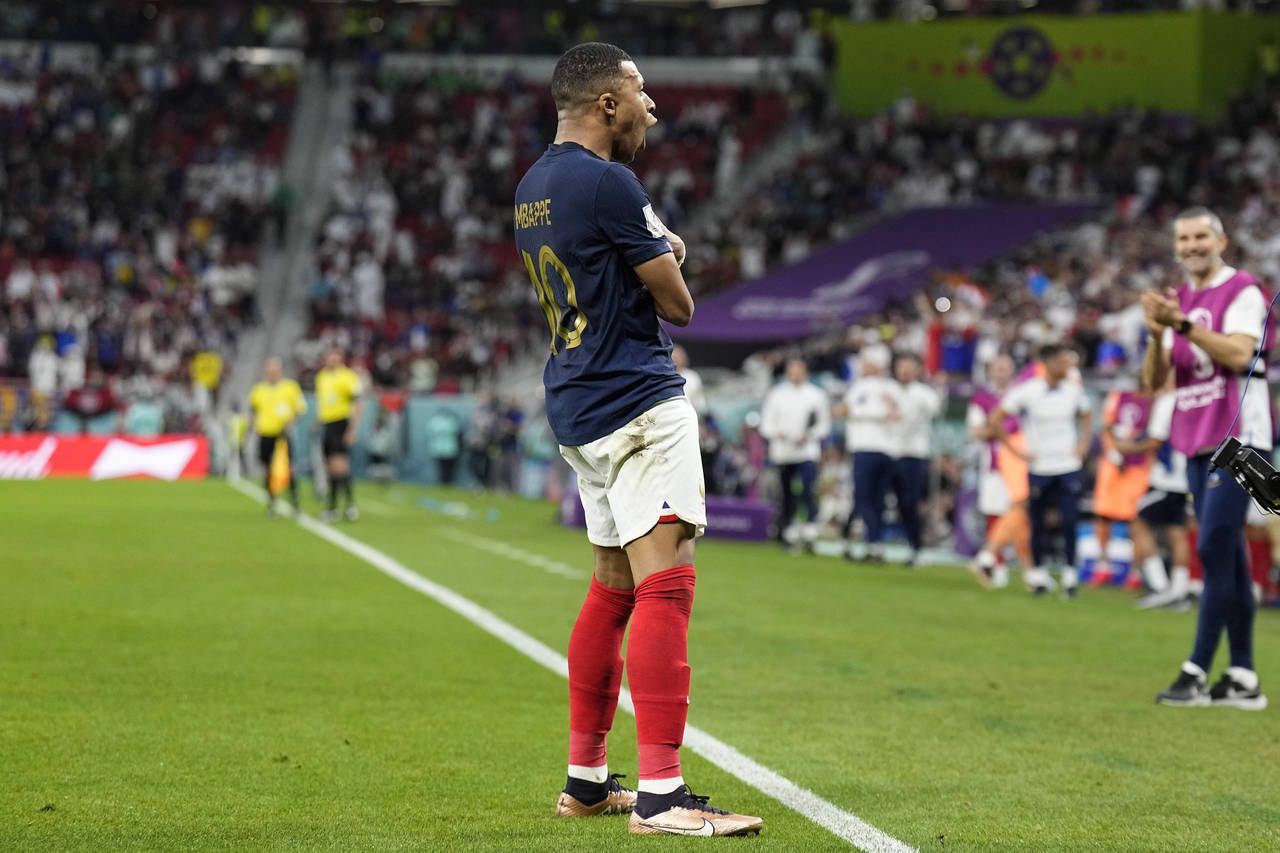 France's Kylian Mbappe celebrates scoring his side's third goal during the World Cup round of 16 so...