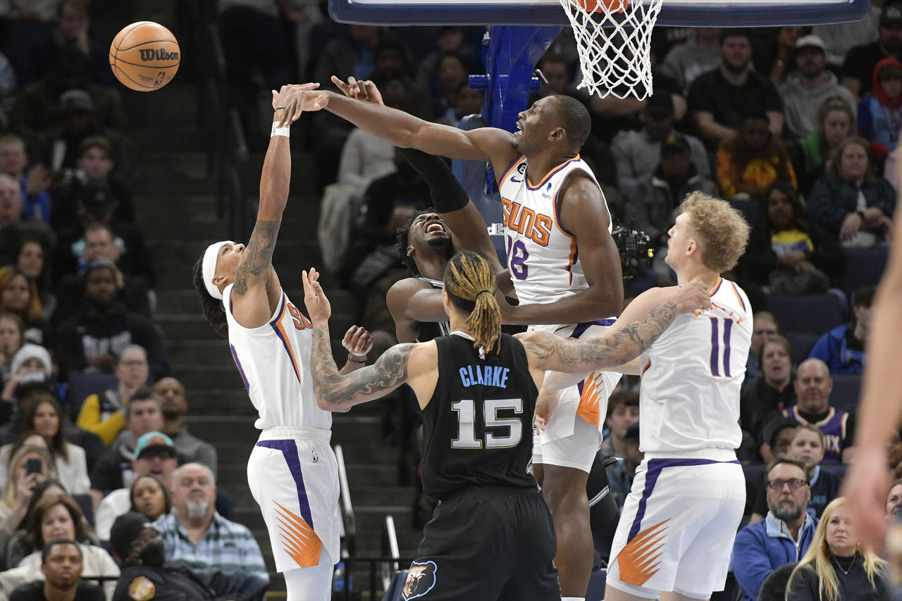 Phoenix Suns center Bismack Biyombo defends against Memphis Grizzlies forward Jaren Jackson Jr. in ...