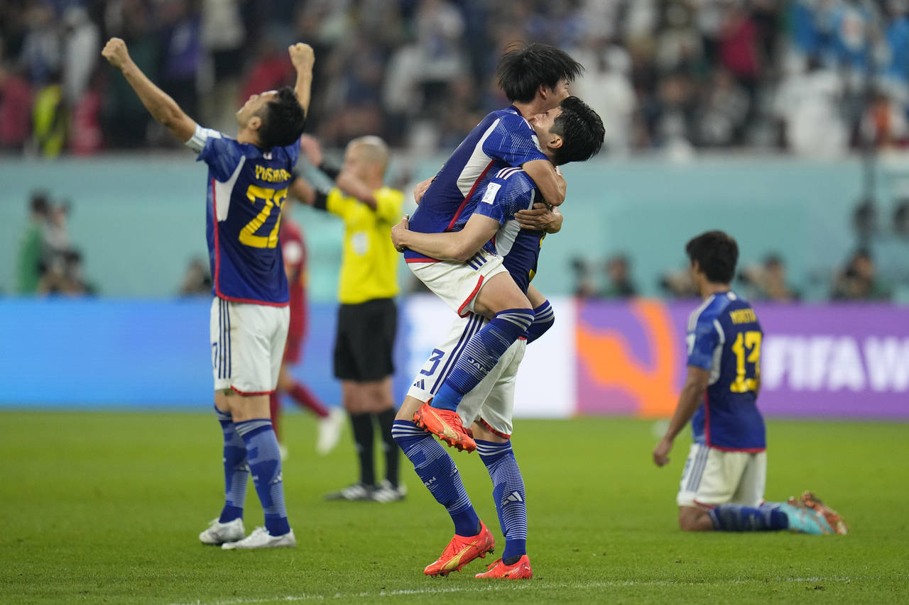 Japan players jubilate at the end of the World Cup group E soccer match between Japan and Spain, at...
