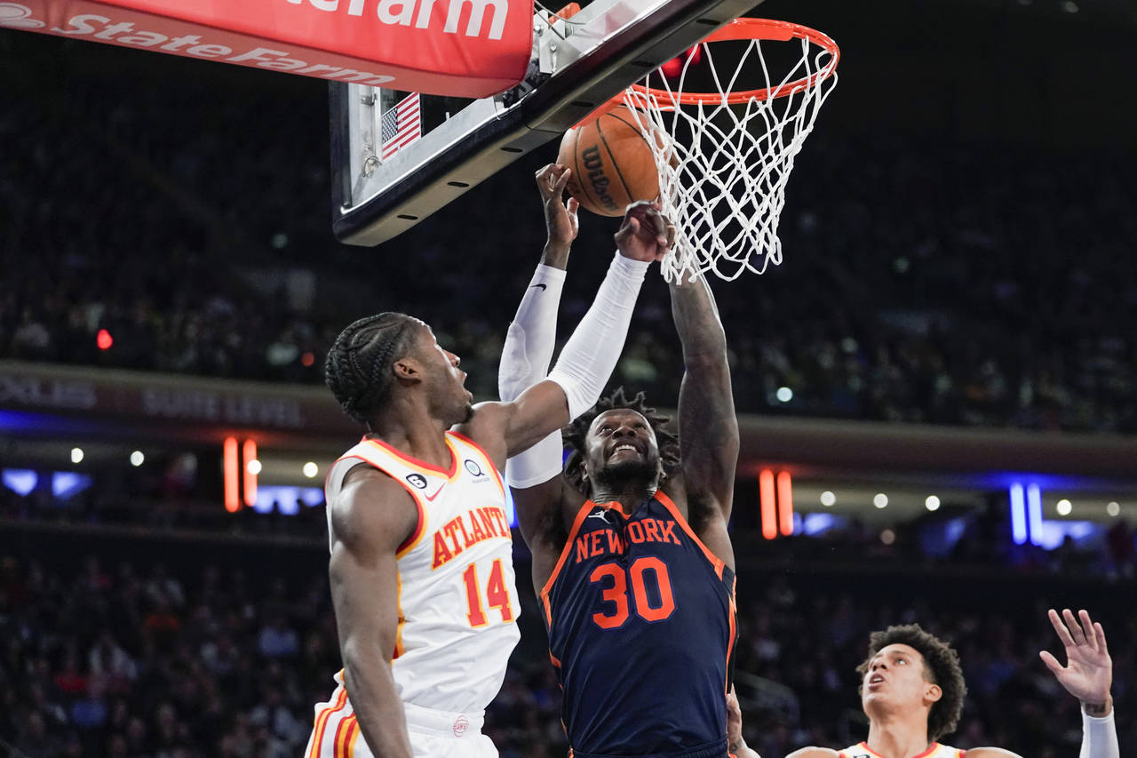 New York Knicks forward Julius Randle (30) and Atlanta Hawks forward AJ Griffin (14) vie for a rebo...