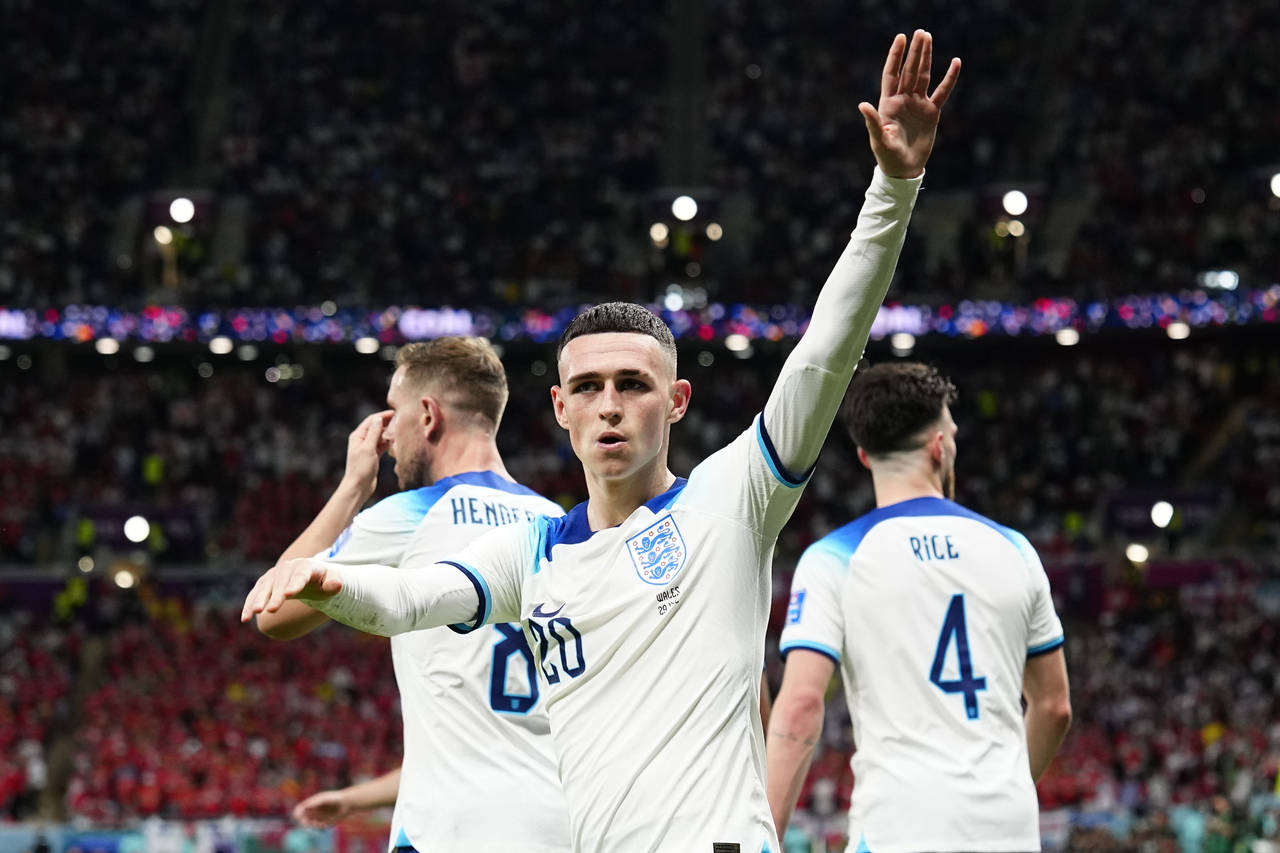 England's Phil Foden waves towards the fans after scoring his side's second goal during the World C...