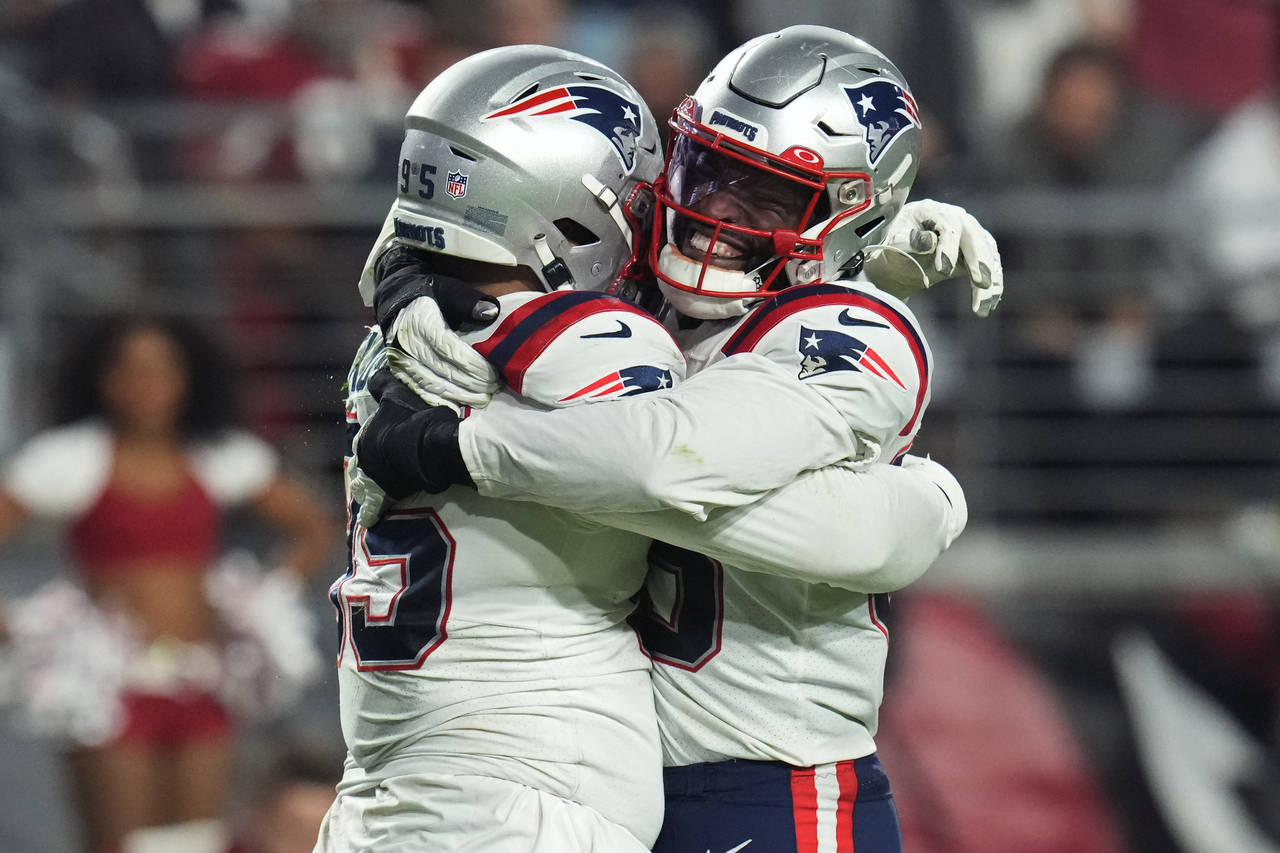 New England Patriots defensive tackle Daniel Ekuale, left, celebrates a sack against the Arizona Ca...