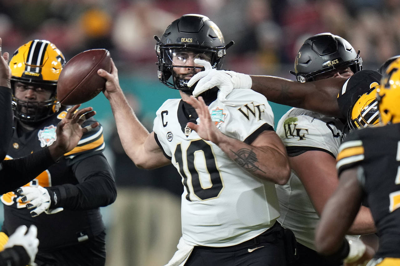 Wake Forest quarterback Sam Hartman (10) gets his pass knocked down by Missouri defensive lineman J...