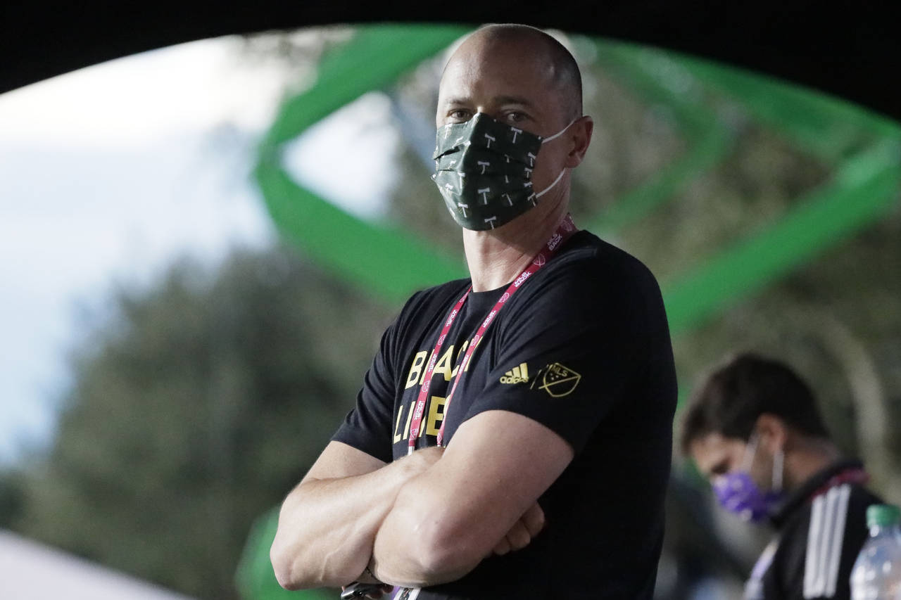 FILE - Portland Timbers team owner Merritt Paulson stands on the sidelines before the first half of...