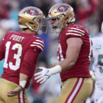 
              San Francisco 49ers quarterback Brock Purdy (13) celebrates after throwing a touchdown pass to running back Christian McCaffrey with offensive tackle Daniel Brunskill, middle, as Miami Dolphins defensive tackle Christian Wilkins (94) reacts during the first half of an NFL football game in Santa Clara, Calif., Sunday, Dec. 4, 2022. (AP Photo/Godofredo A. Vásquez)
            