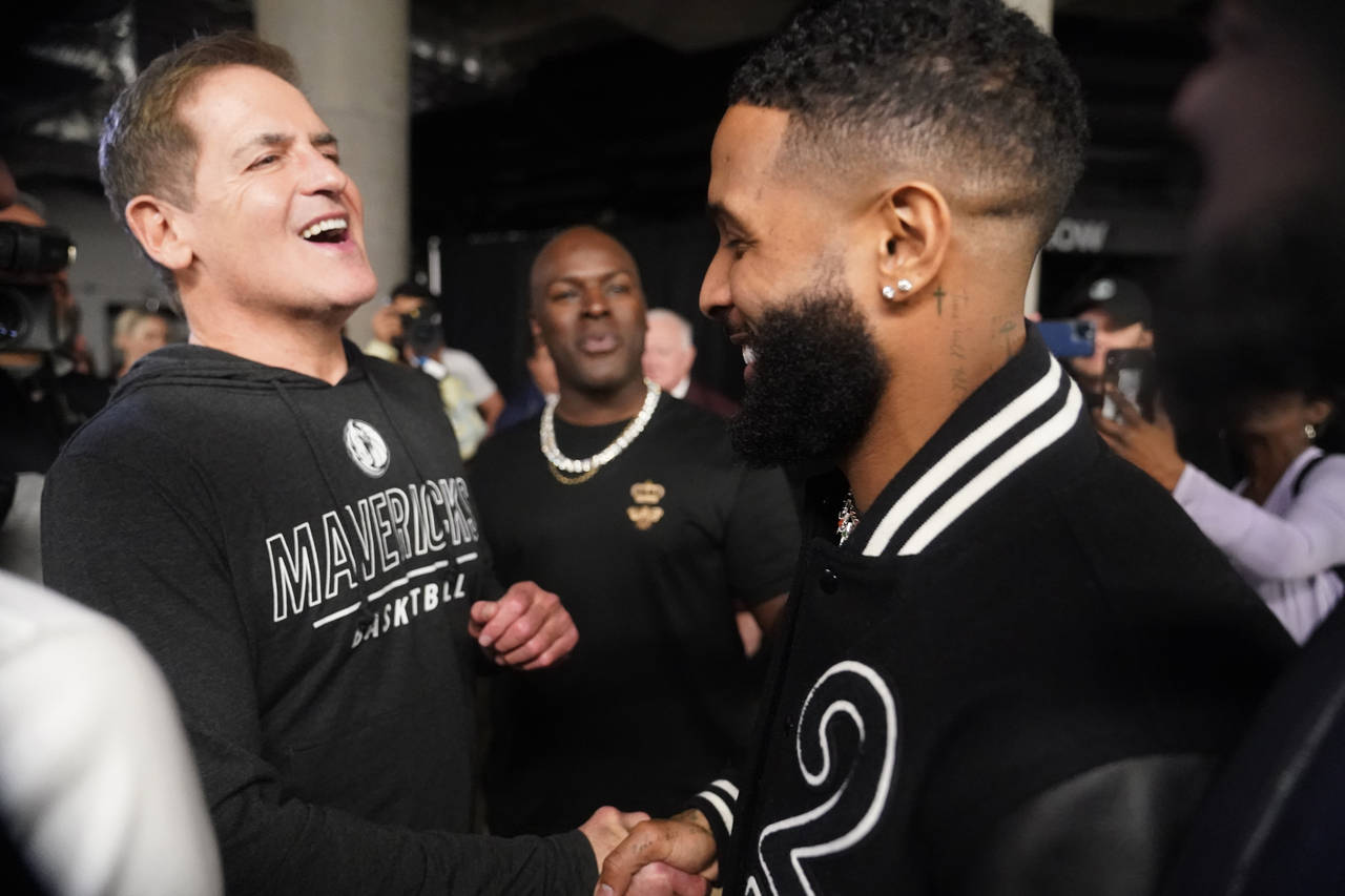 Dallas Mavericks owner Marc Cuban, left, greets NLF football free agent Odell Beckham Jr. after an ...