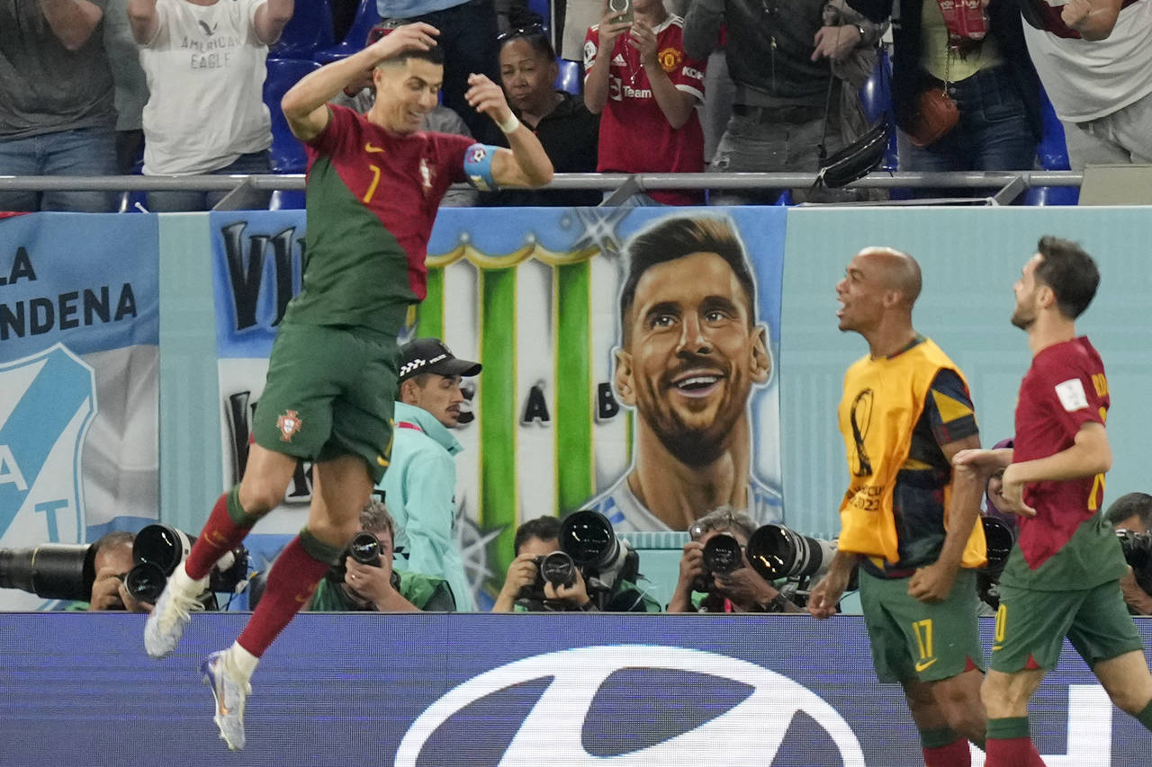 Poster with picture of Argentina's Lionel Messi hangs from a tribune as Portugal's Cristiano Ronald...