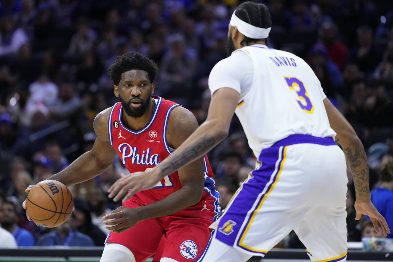 Philadelphia 76ers' Joel Embiid, left, tries to get past Los Angeles Lakers' Anthony Davis during t...