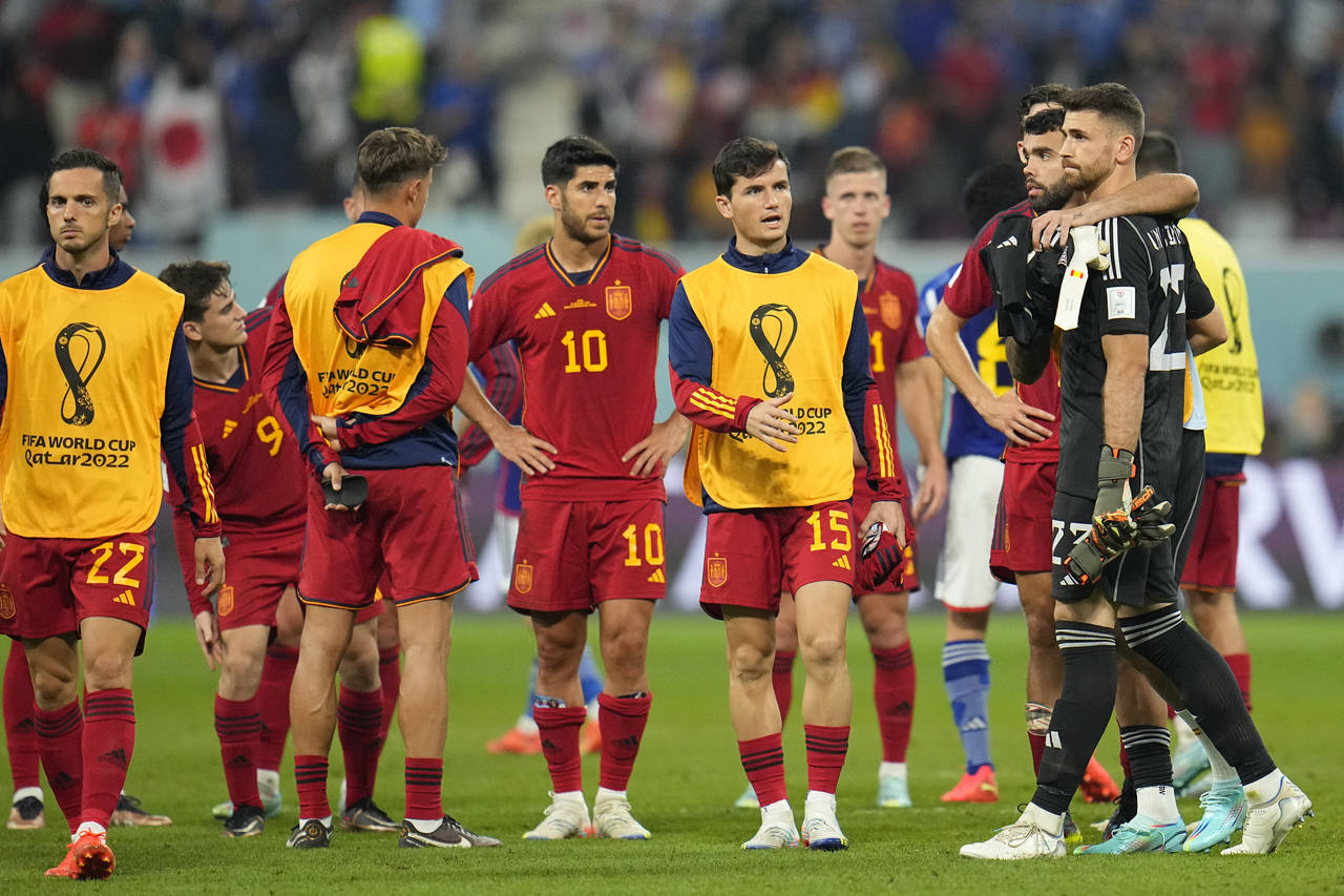 Spain players leave the pitch at the end of the World Cup group E soccer match between Japan and Sp...