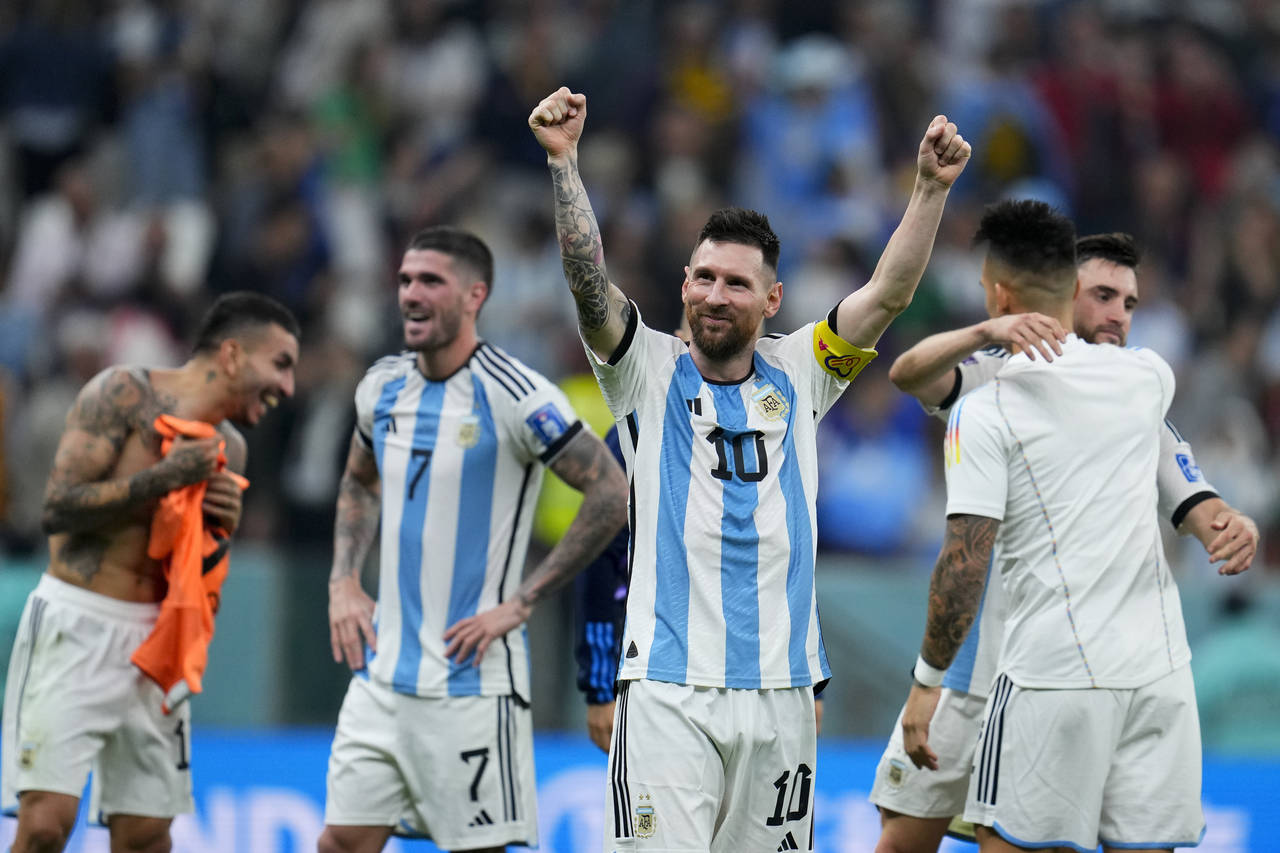 Argentina's Lionel Messi celebrates defeating Croatia 3-0 in a World Cup semifinal soccer match at ...