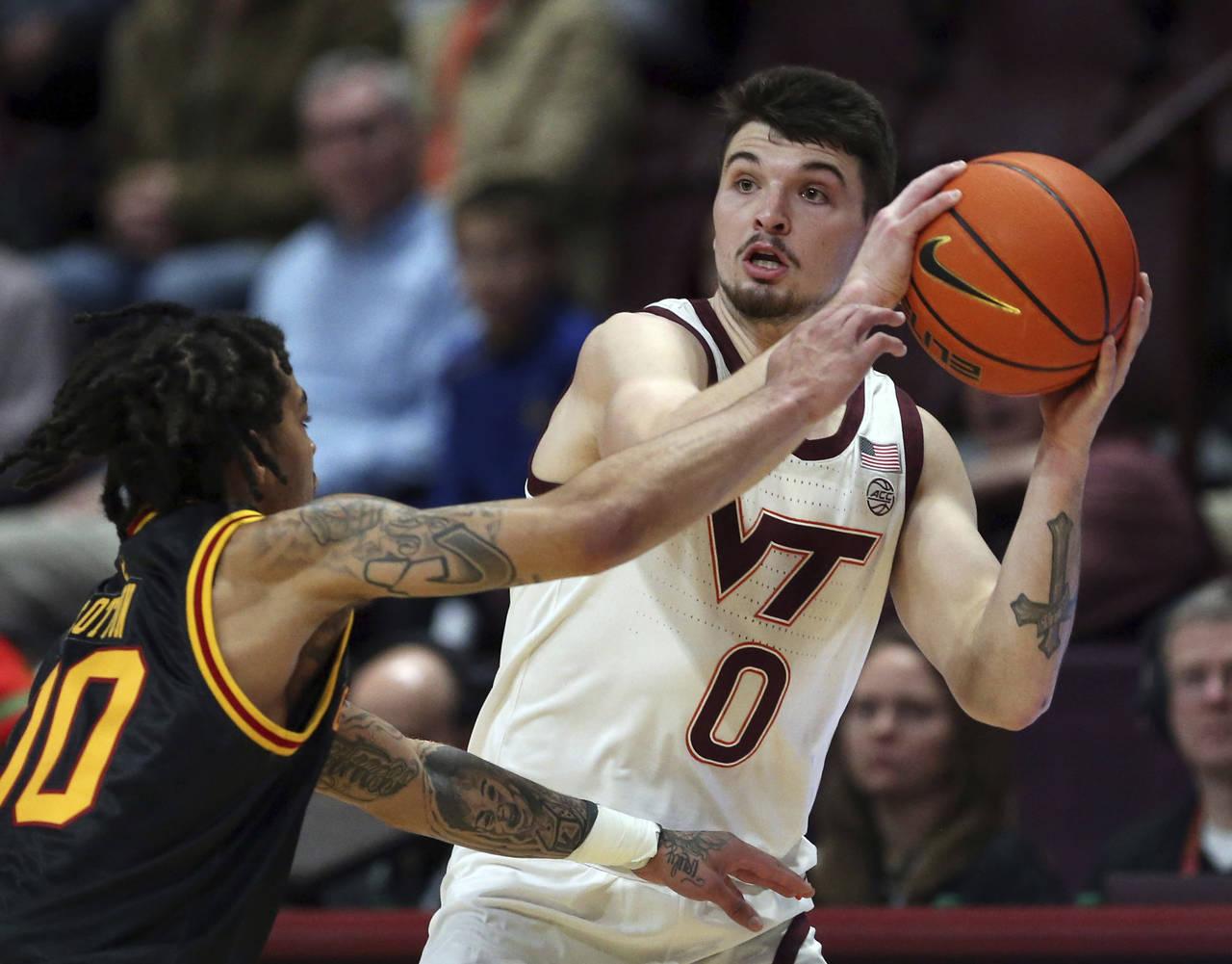 Virginia Tech's Hunter Cattoor (0) looks to pass while guarded by Grambling State's Virshon Cotton ...