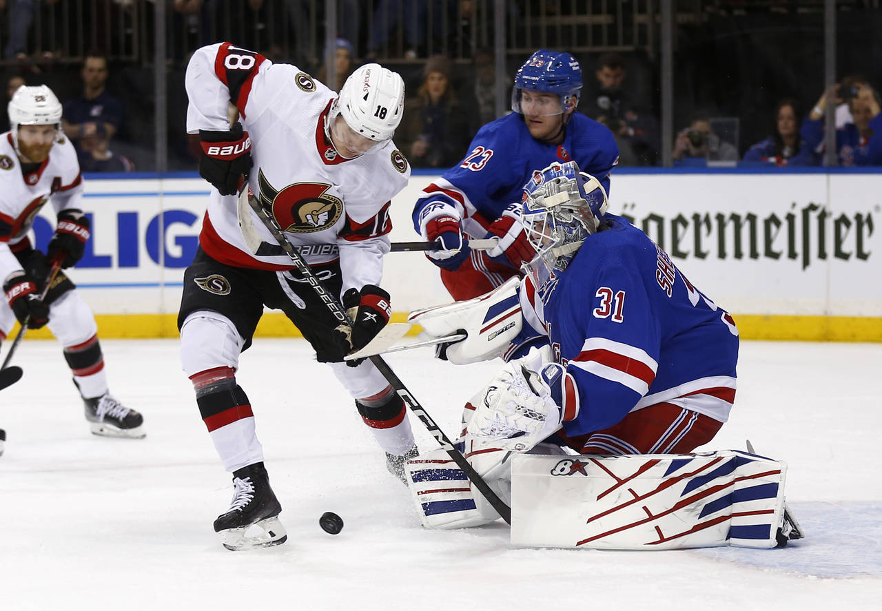 New York Rangers goalie Igor Shesterkin (31) stops Ottawa Senators left wing Tim Stutzle (18) as Ra...