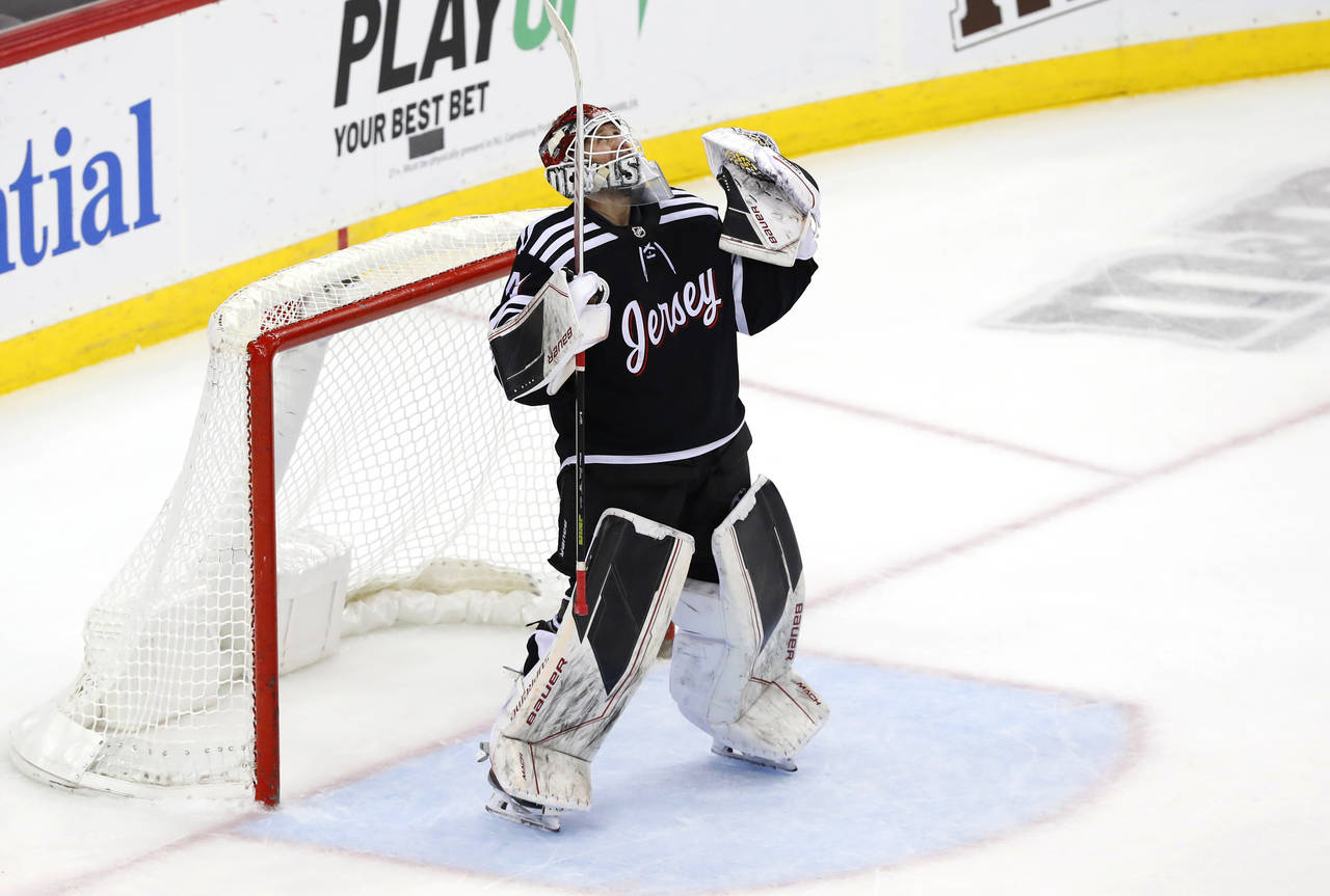 New Jersey Devils goaltender Akira Schmid celebrates the team's 3-0 win over Chicago Blackhawks in ...