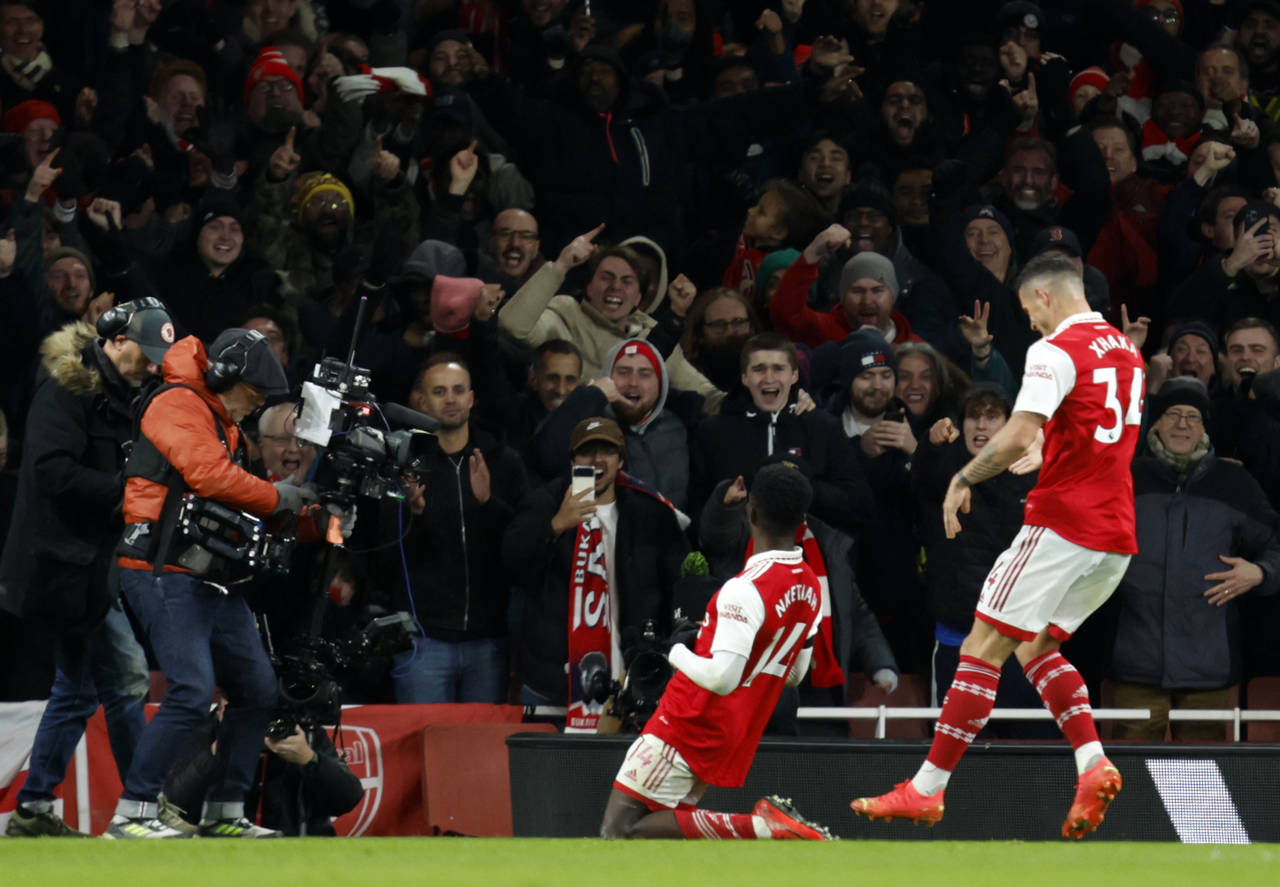 Arsenal's Eddie Nketiah, center, celebrates after scoring his side's third goal during the English ...