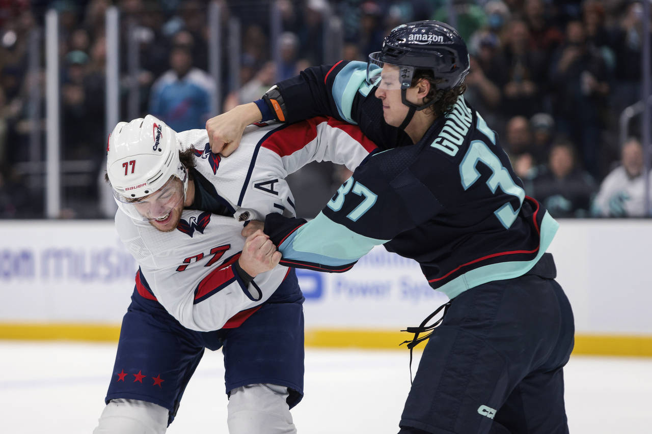 Washington Capitals right wing T.J. Oshie (77) and Seattle Kraken center Yanni Gourde fight during ...