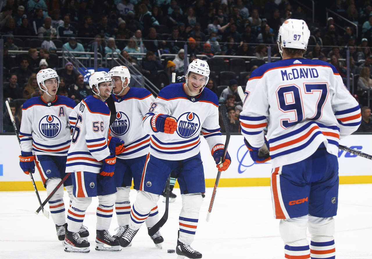 Edmonton Oilers left wing Zach Hyman (18) celebrates with teammates after scoring against the Seatt...