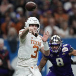 
              Texas quarterback Quinn Ewers (3) throws under pressure from Washington defensive lineman Bralen Trice (8) during the second half of the Alamo Bowl NCAA college football game in San Antonio, Thursday, Dec. 29, 2022. (AP Photo/Eric Gay)
            