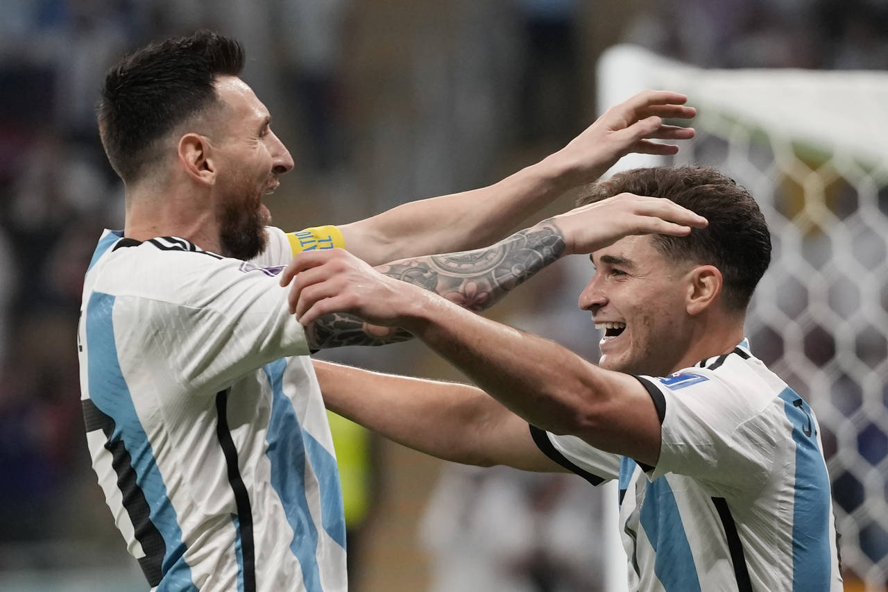 Argentina's Julian Alvarez, right, and Lionel Messi, left, celebrate their side's second goal durin...