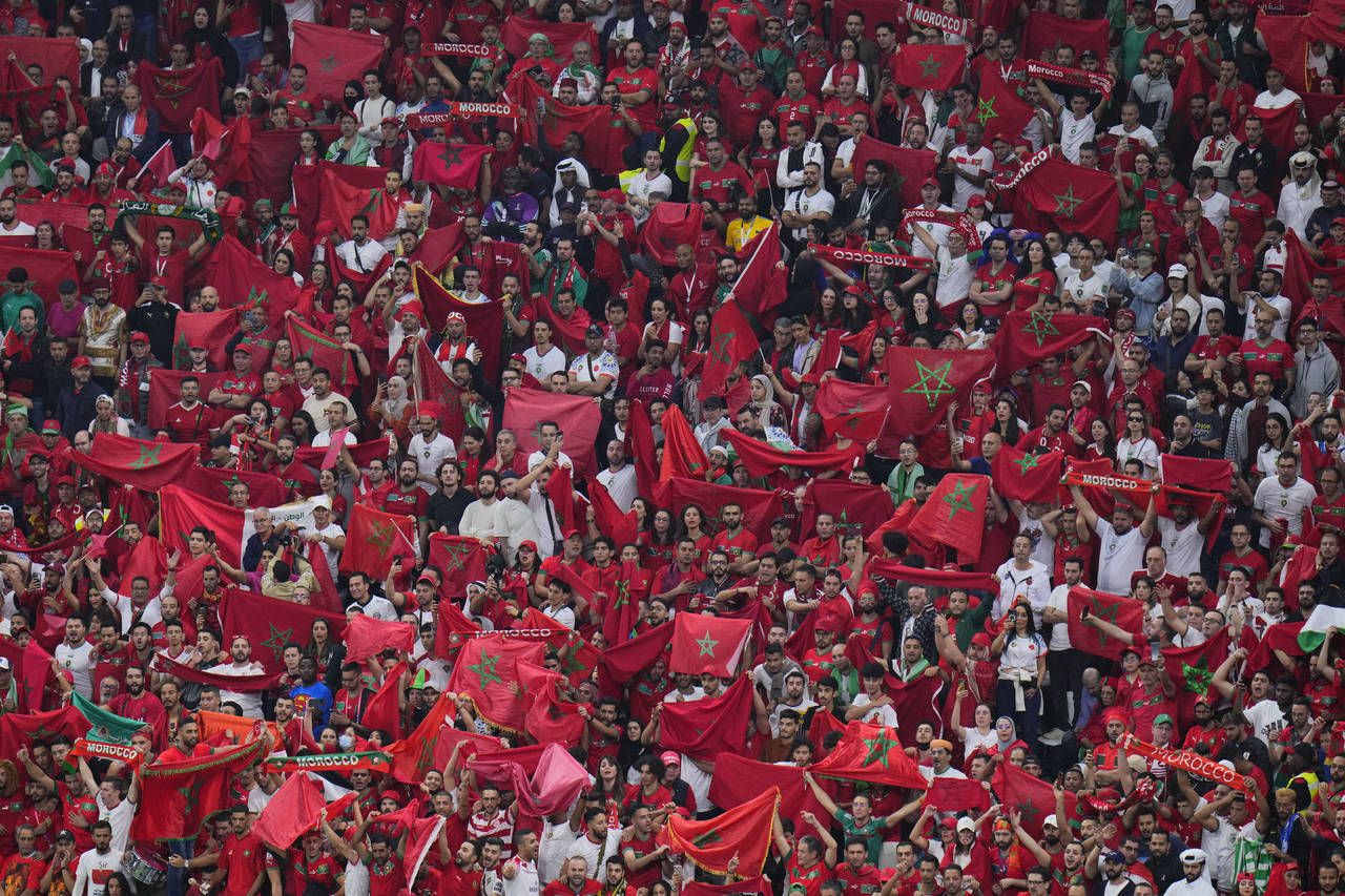 Moroccan fans cheer during the World Cup semifinal soccer match between France and Morocco at the A...
