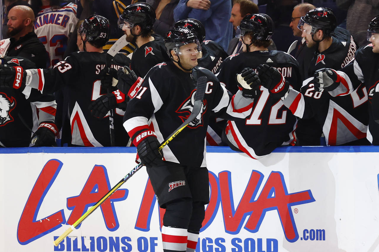 Buffalo Sabres right wing Kyle Okposo (21) is congratulated for his second goal against the Detroit...