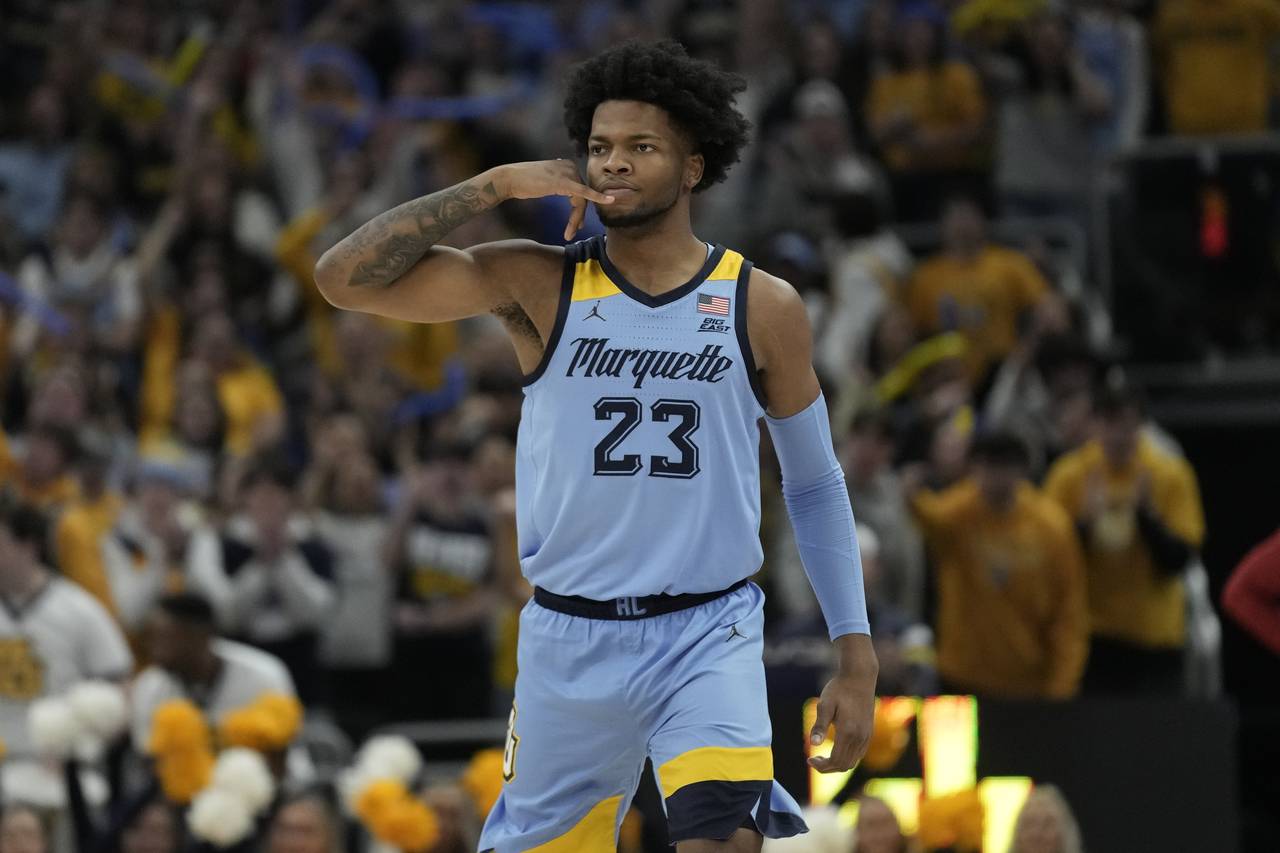 Marquette's David Joplin reacts to his three-pointer during the second half of an NCAA college bask...