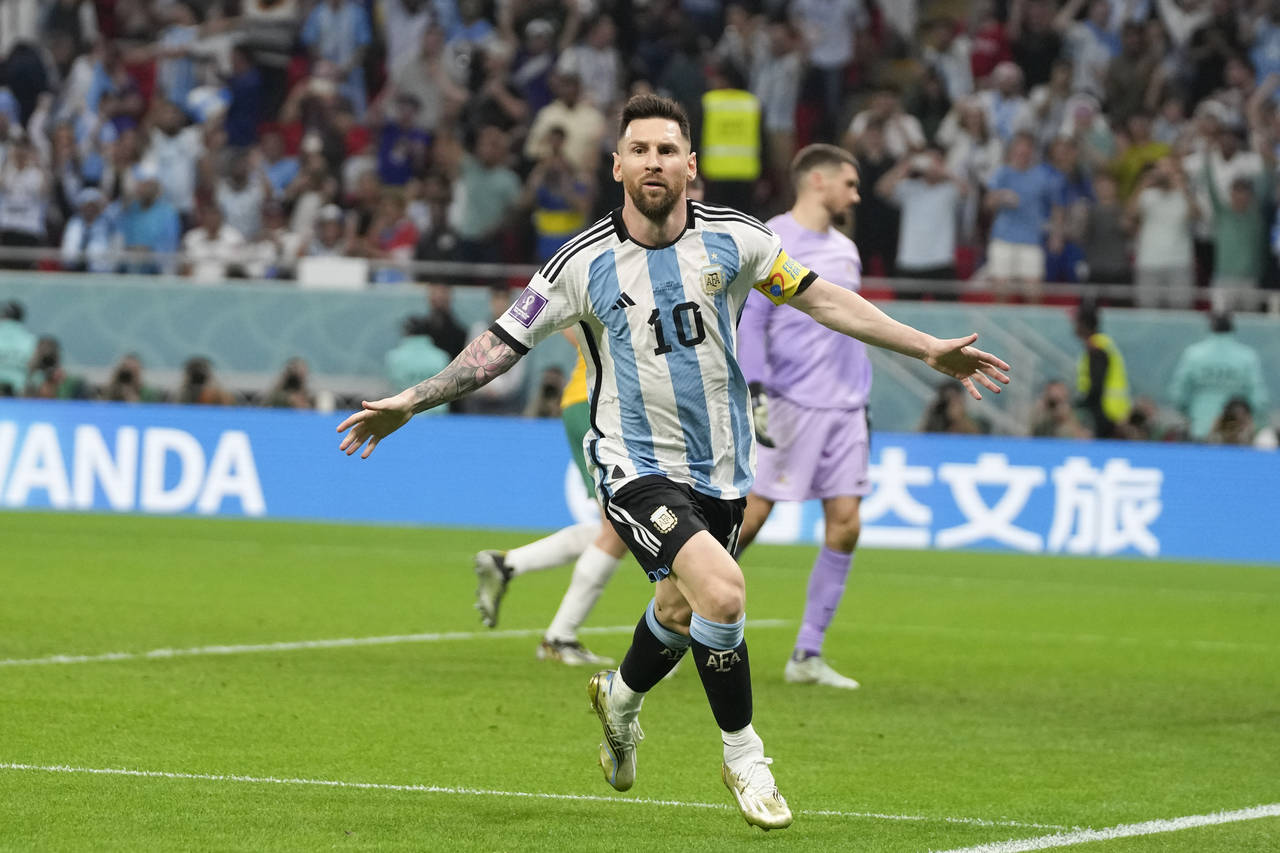 Argentina's Lionel Messi celebrates scoring the opening goal during the World Cup round of 16 socce...