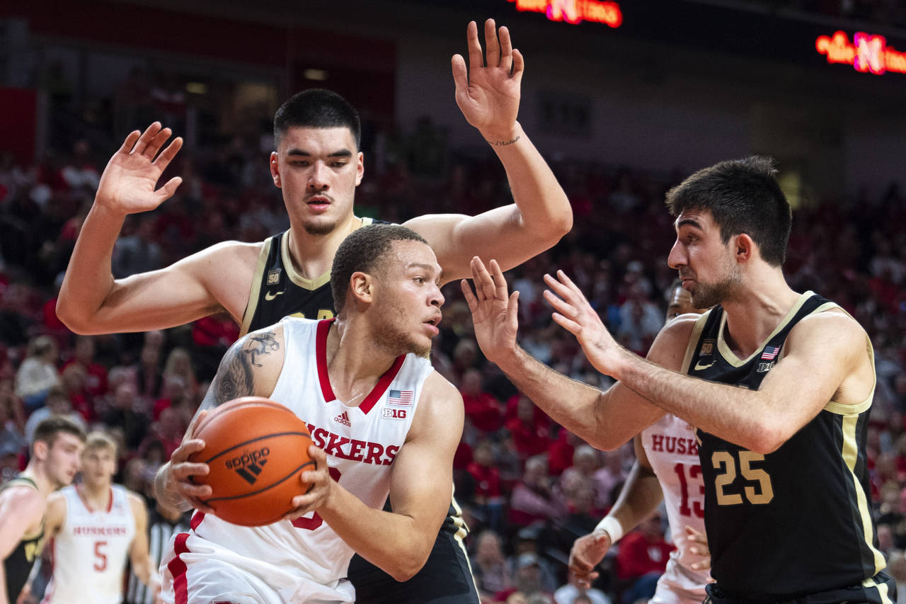 Nebraska's C.J. Wilcher is guarded by Purdue's Zach Edey, top left, and Ethan Morton during the fir...