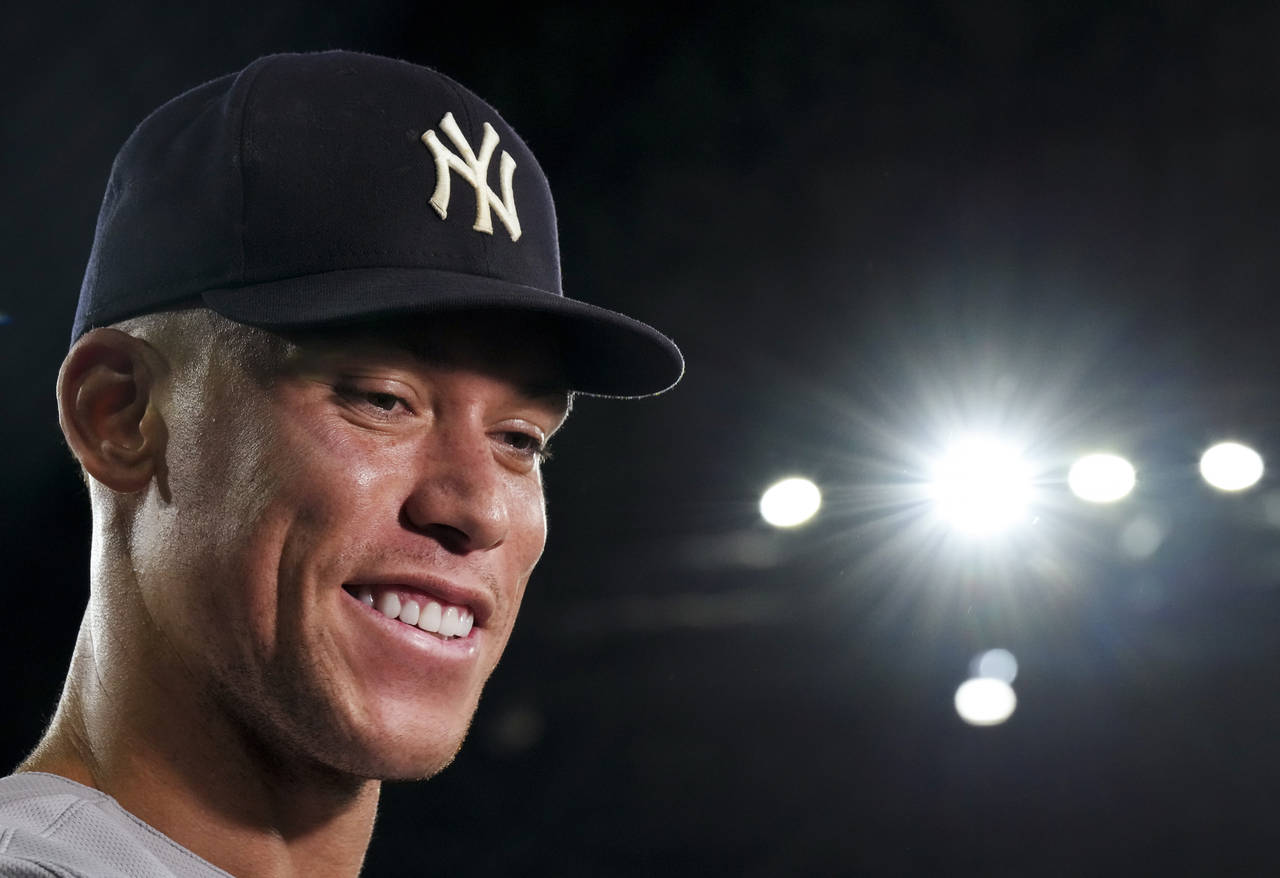 FILE -New York Yankees' Aaron Judge smiles as he speaks during an interview after the team's baseba...