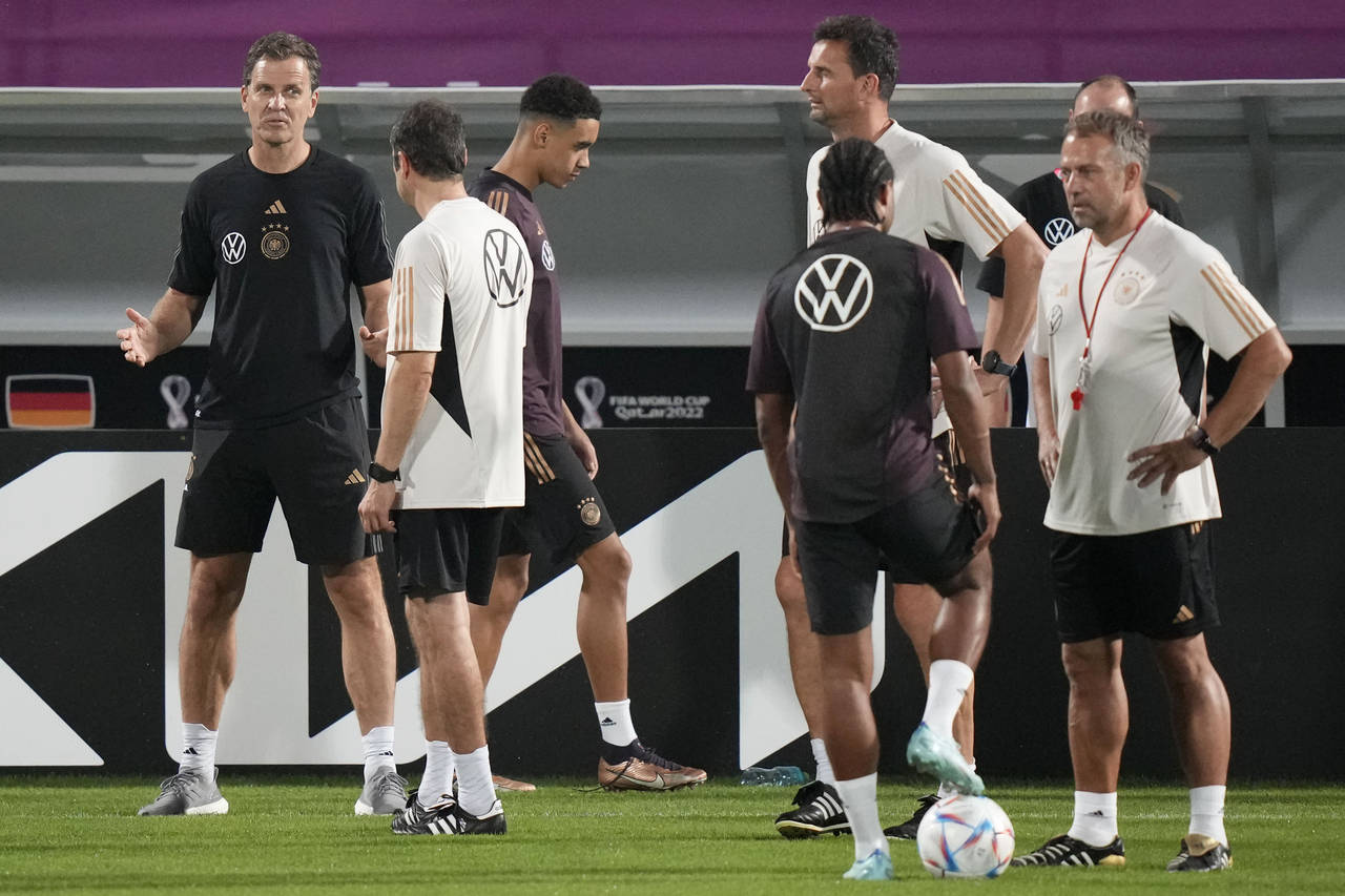 FILE - Germany's manager Oliver Bierhoff, left, talks to coaches besides head coach Hans Flick, rig...