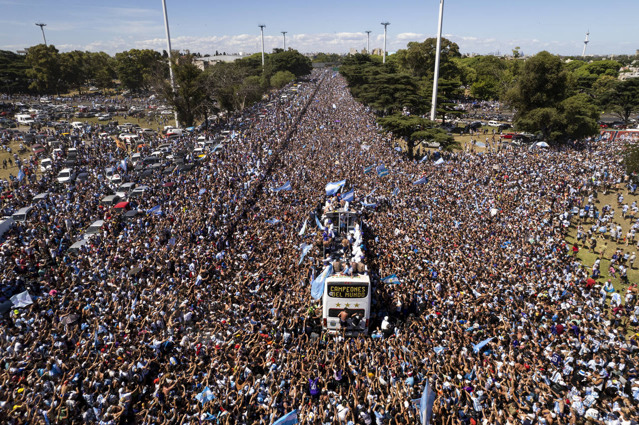 The Argentine soccer team that won the World Cup title ride on an open bus during their homecoming ...