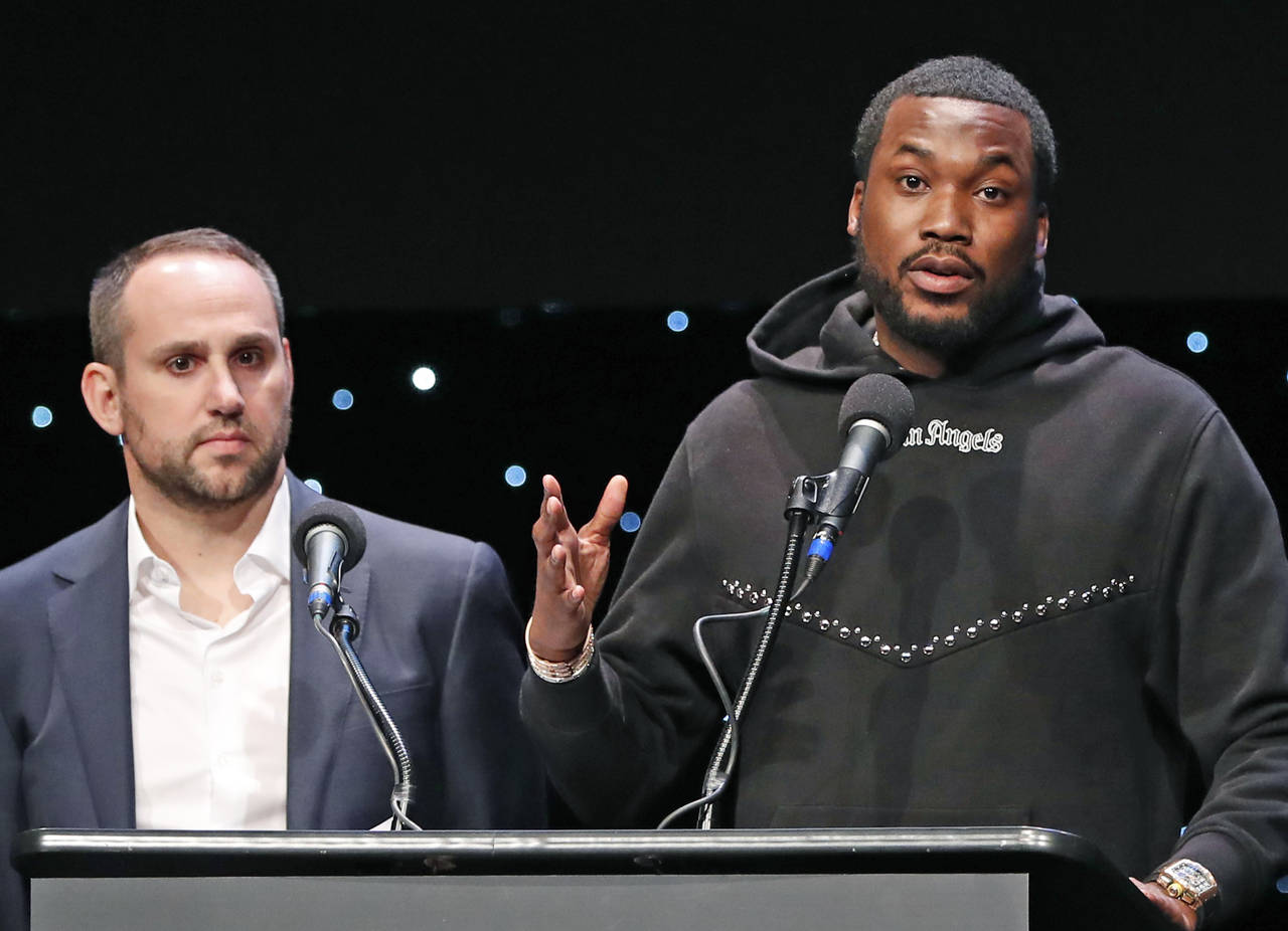FILE - Musician Meek Mill, right, speaks about his incarceration along with Philadelphia 76ers co-o...