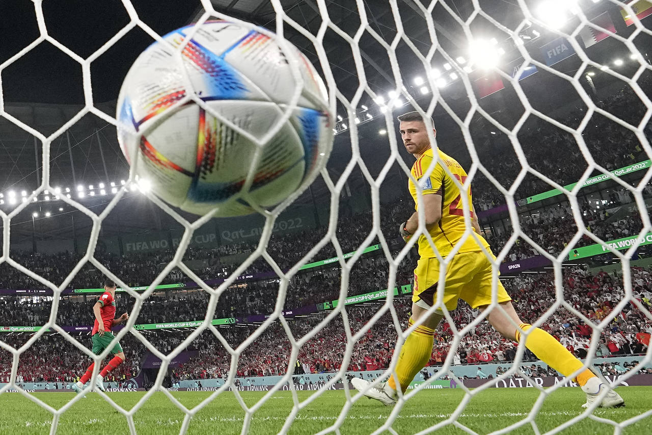 Spain's goalkeeper Unai Simon looks round after Morocco's Achraf Hakimi scored the winning penalty ...