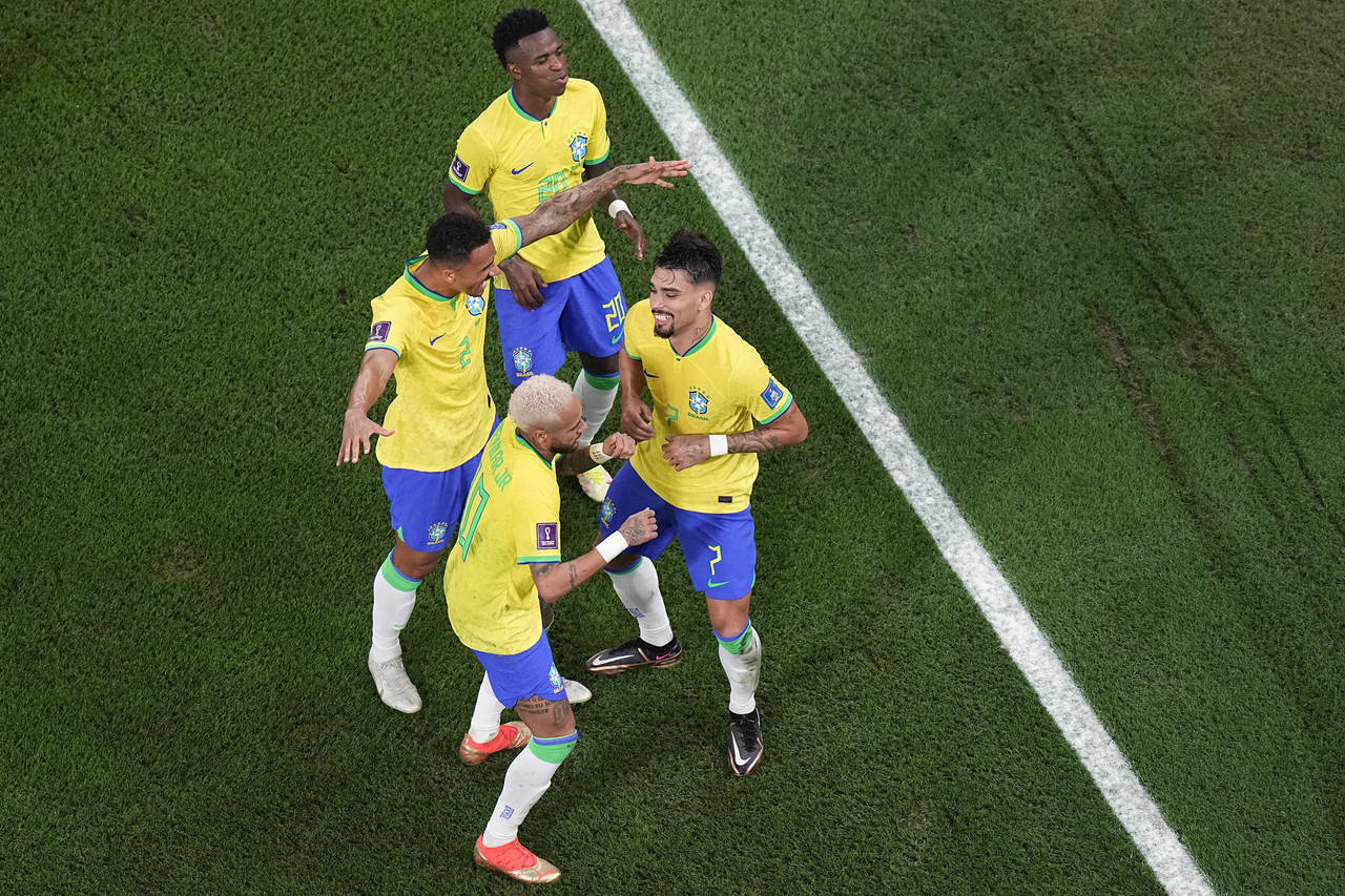 Brazil's Vinicius Junior, Danilo and Neymar dance with Lucas Paqueta, right, after he scored his si...