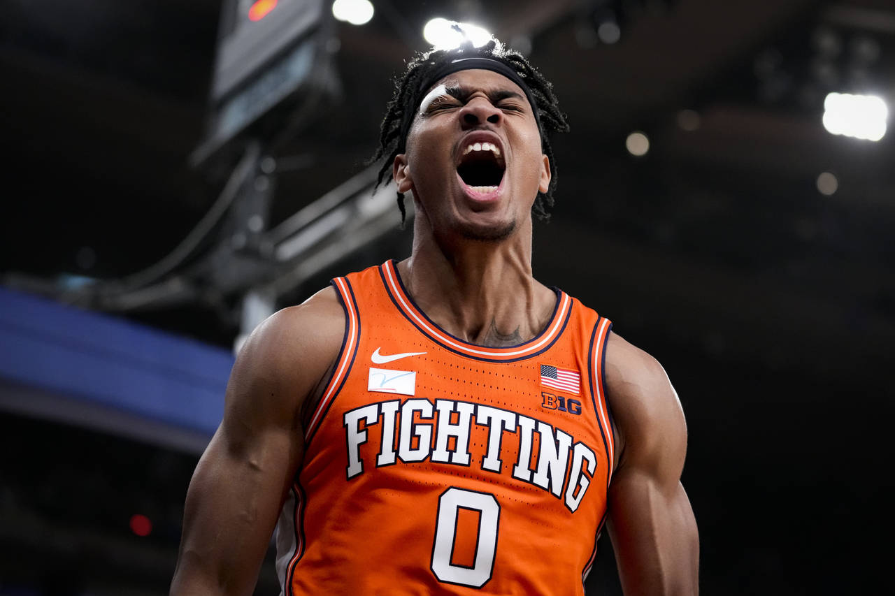 Illinois' Terrence Shannon Jr. (0) reacts after scoring and drawing a foul in overtime during the t...