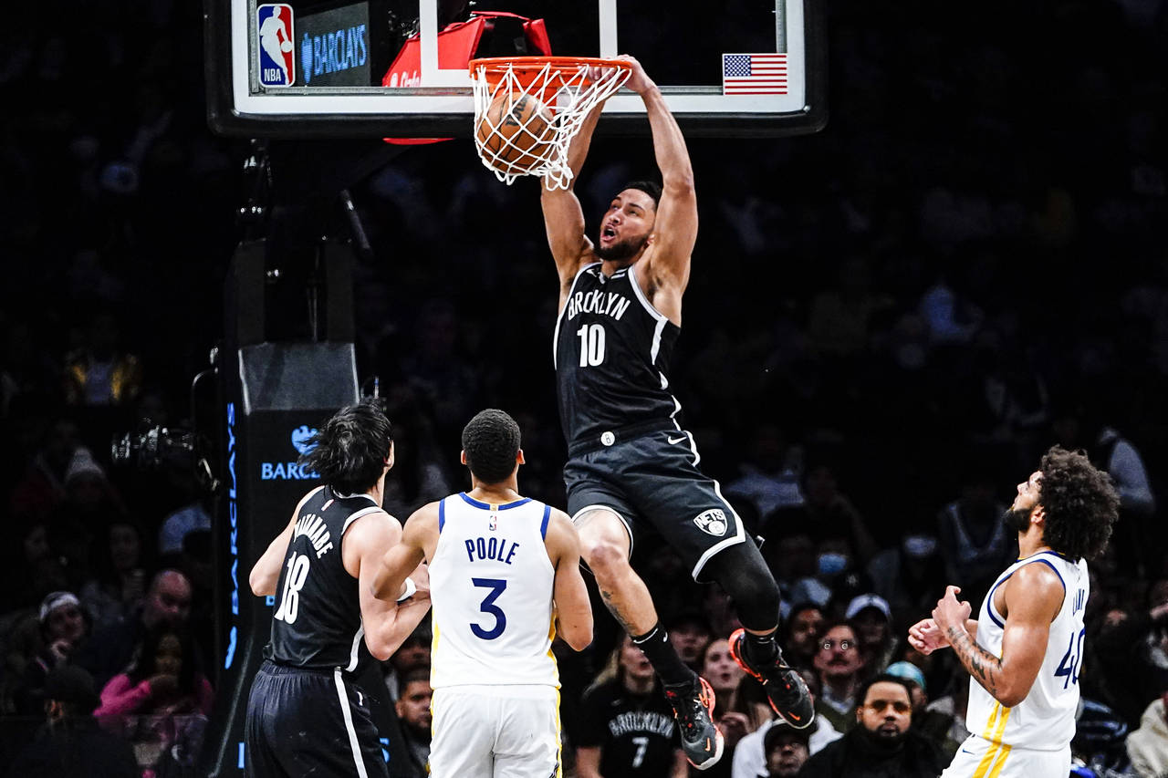 Brooklyn Nets' Ben Simmons (10) dunks the ball in front of Golden State Warriors' Jordan Poole (3) ...