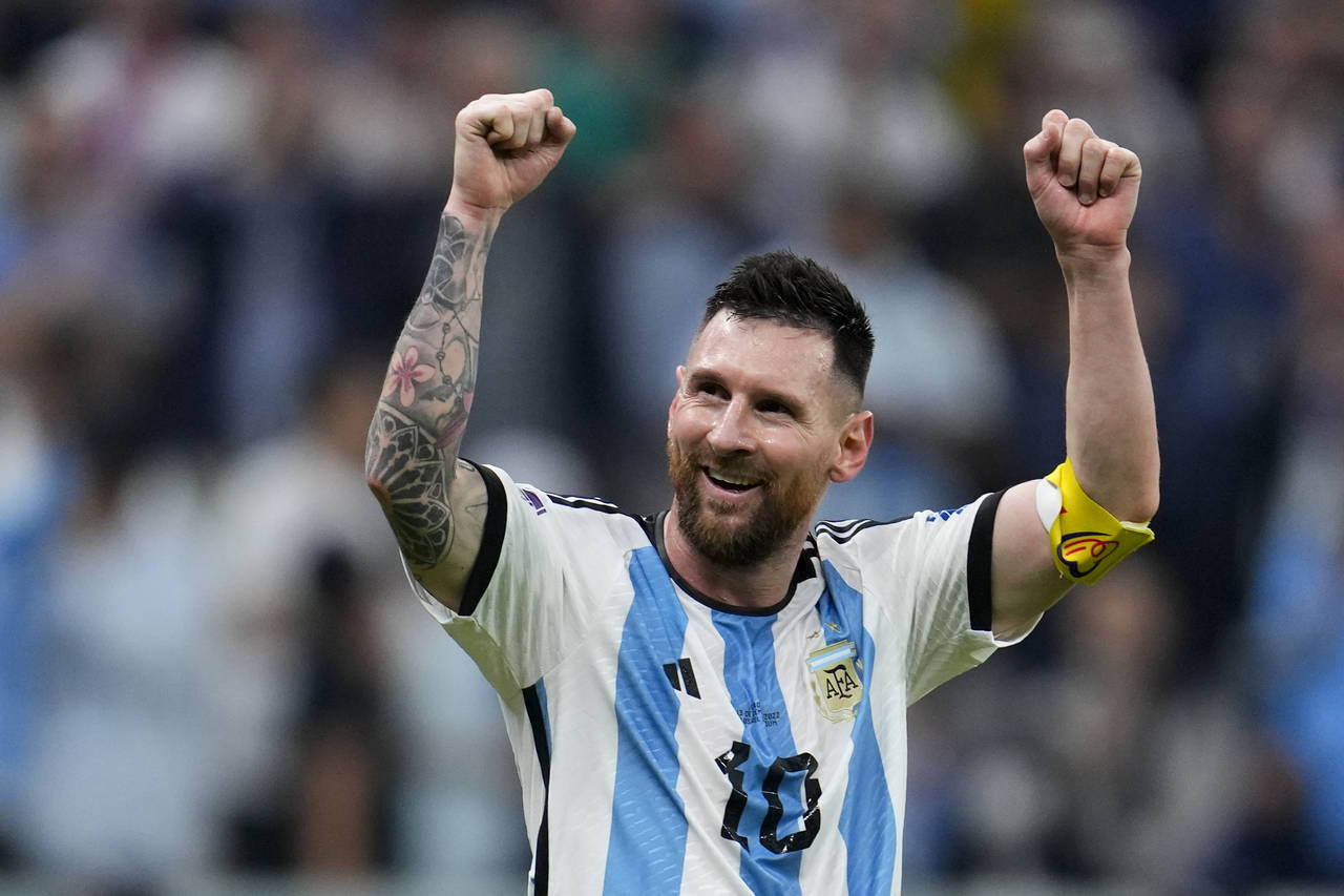 Argentina's Lionel Messi celebrates after his teammate Julian Alvarez scored his side's third goal ...