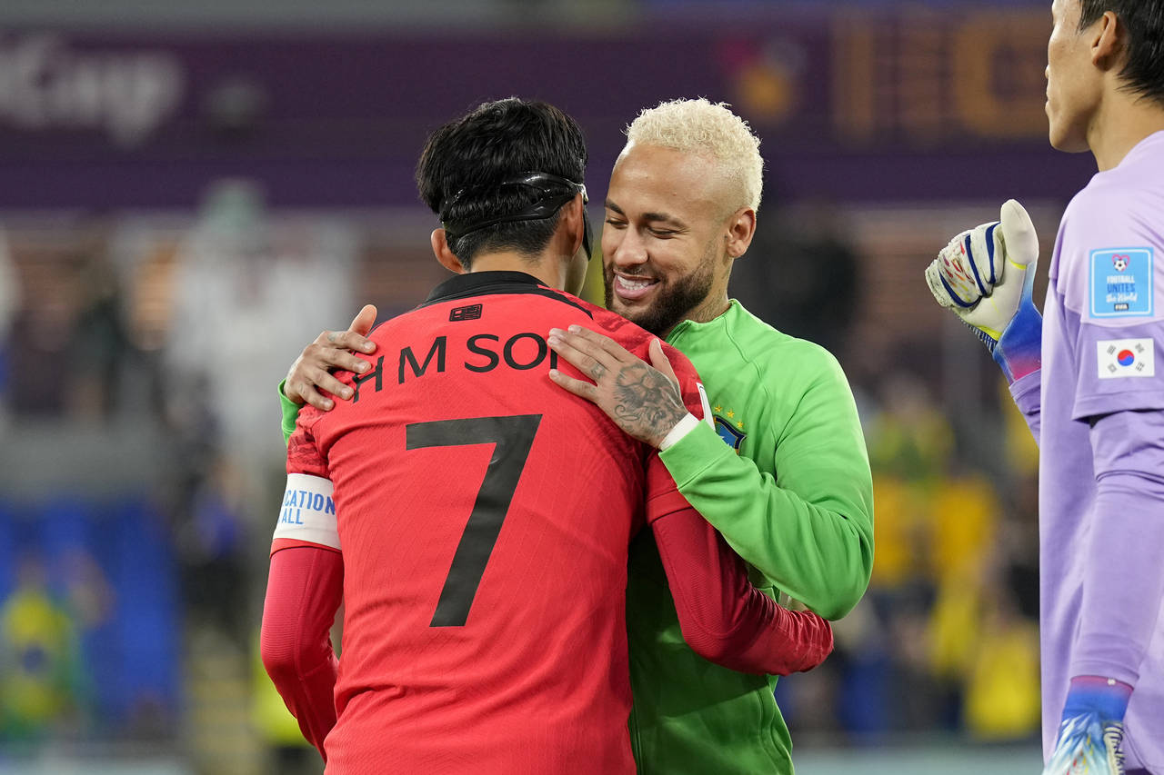 South Korea's Son Heung-min, left, greets Brazil's Neymar before the start of the World Cup round o...