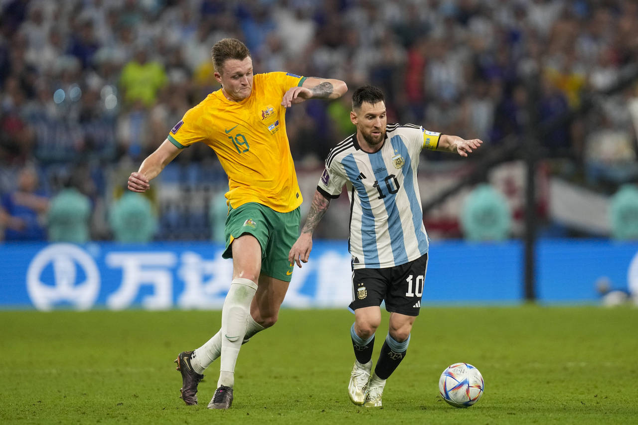 Australia's Harry Souttar chases Argentina's Lionel Messi during the World Cup round of 16 soccer m...