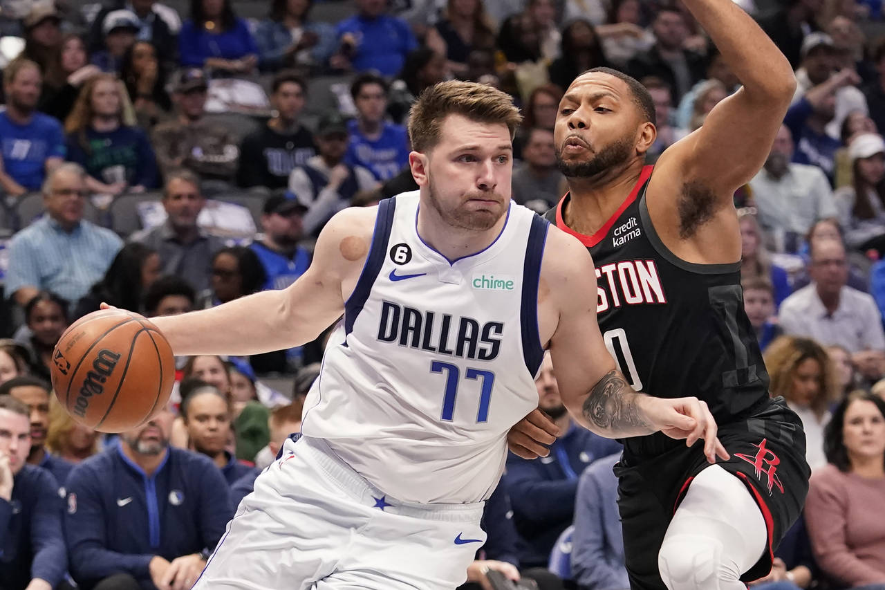 Dallas Mavericks guard Luka Doncic (77) drives against Houston Rockets guard Eric Gordon (10) durin...