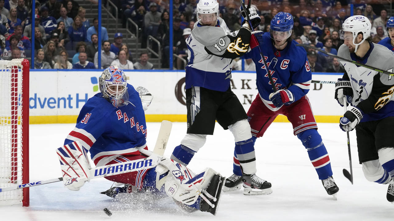 New York Rangers goaltender Igor Shesterkin (31) makes a sliding save as defenseman Jacob Trouba (8...