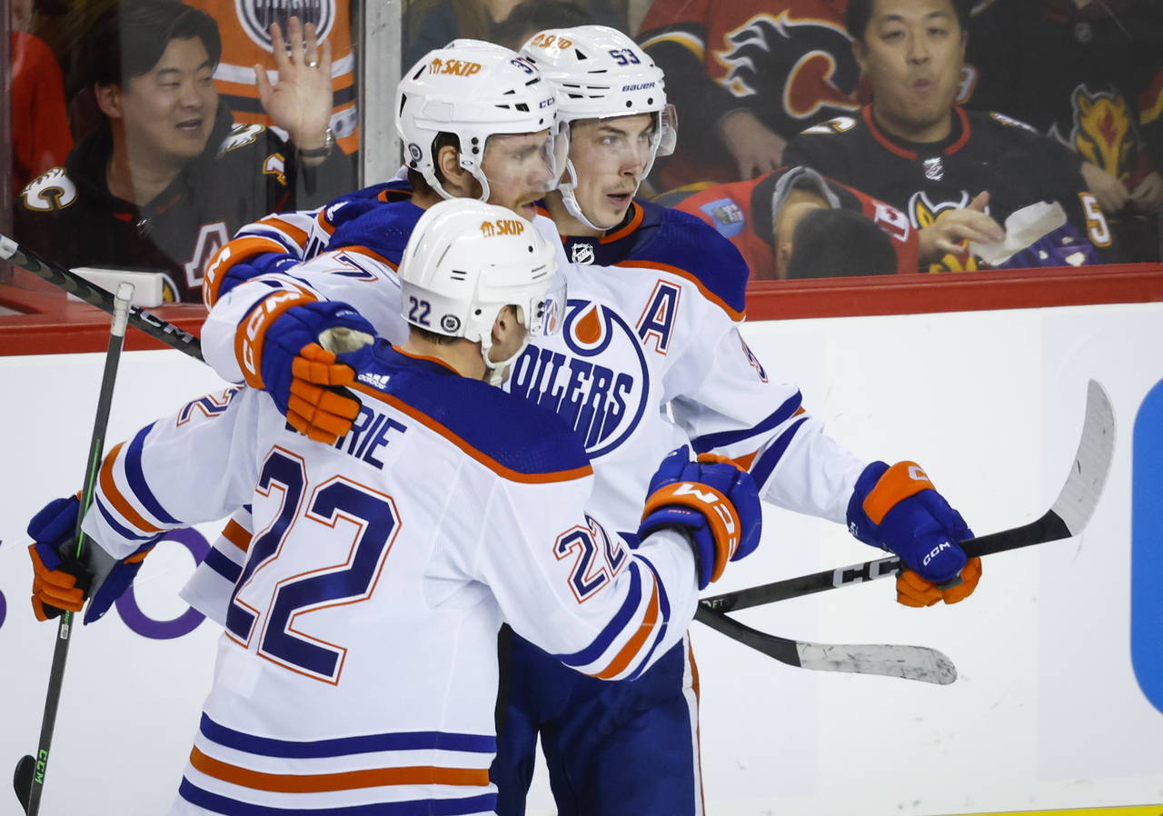 Edmonton Oilers forward Connor McDavid, center, celebrates his goal with teammate defenseman Tyson ...