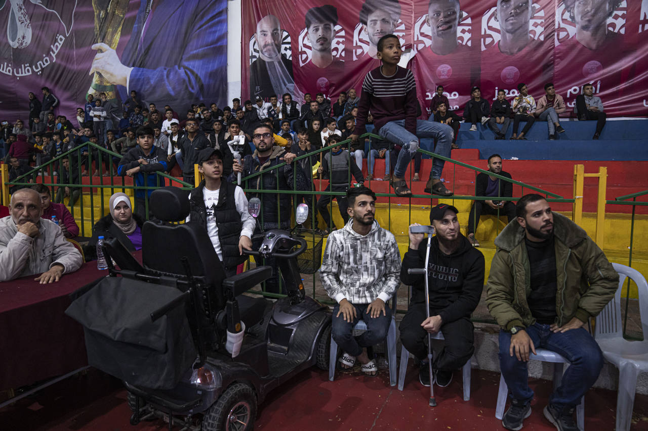 Palestinians watch a live broadcast of the World Cup third-place playoff soccer match between Moroc...