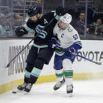 
              Vancouver Canucks center Bo Horvat (53) works against Seattle Kraken defenseman Adam Larsson (6) for the puck during the first period of an NHL hockey game Wednesday, Jan. 25, 2023, in Seattle. (AP Photo/John Froschauer)
            